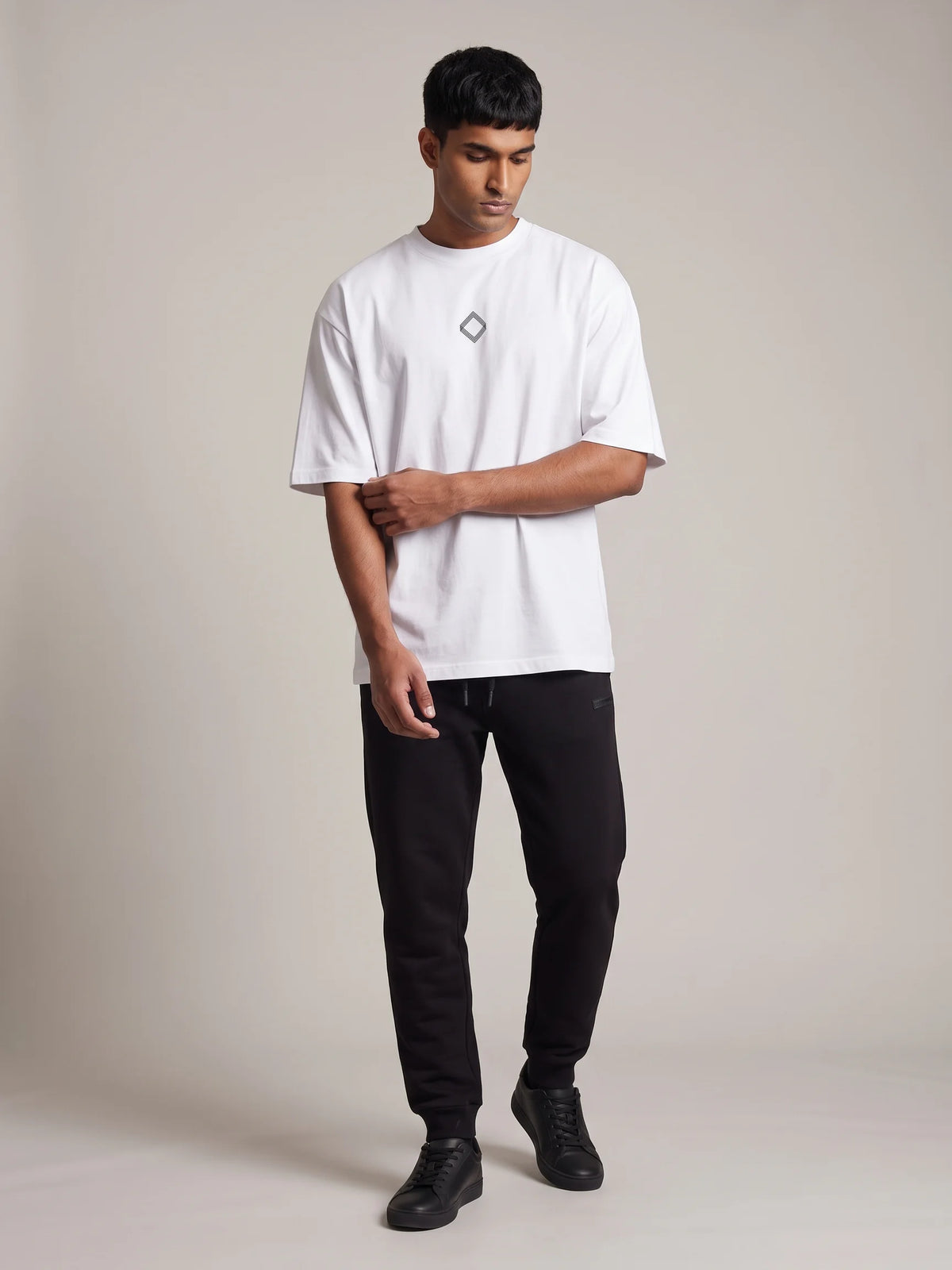 White organic cotton t-shirt, Unidentity Trace Oversized Tee, full-length front view with diamond chest logo, streetwear from the UAE #color_white
