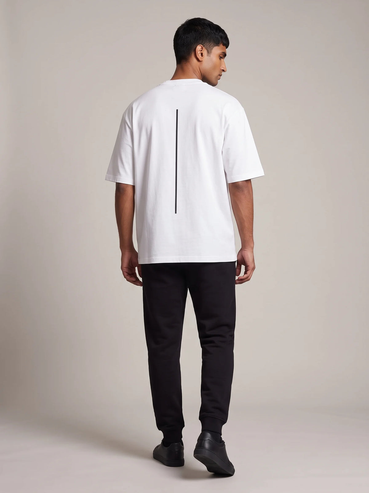 White heavyweight oversized t-shirt, Unidentity Trace Tee, full-length back view of the vertical line print with black Core joggers, streetwear #color_white