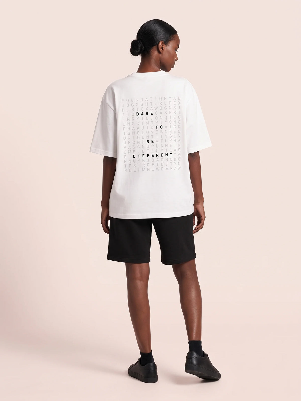 White oversized t-shirt in organic cotton, Unidentity Dare Tee, three-quarter back view of the word search print and dropped shoulders, 210gsm #color_white