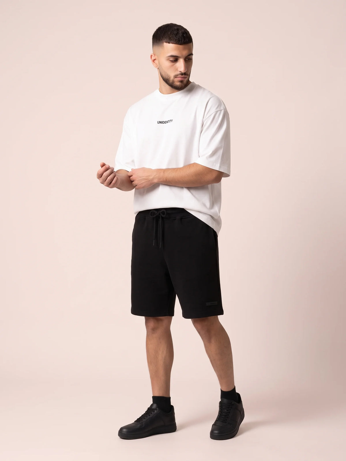 White organic cotton t-shirt, Unidentity Dare Oversized Tee, full-length front view with small chest logo and black Core shorts, streetwear #color_white