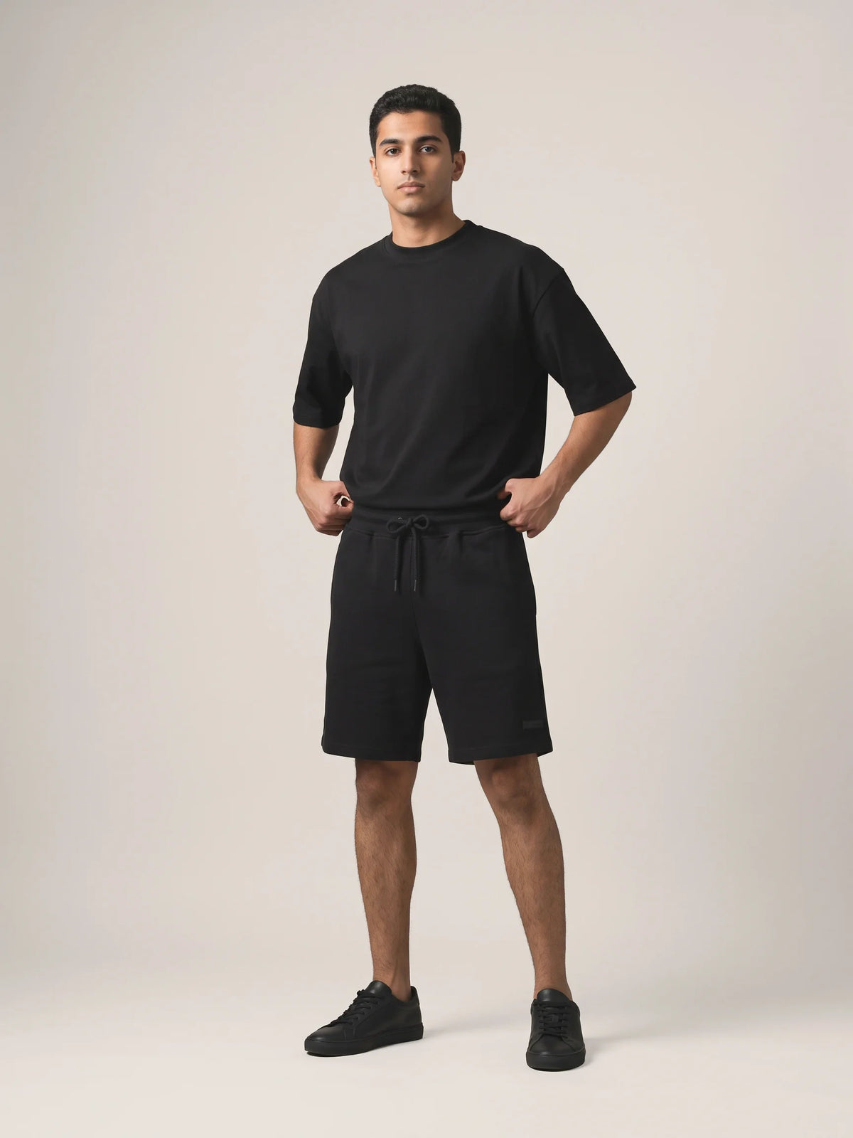 Black heavyweight oversized t-shirt, Unidentity You Tee, full-length front view in a tonal all-black look with Core Regular Fit Shorts, UAE streetwear #color_black