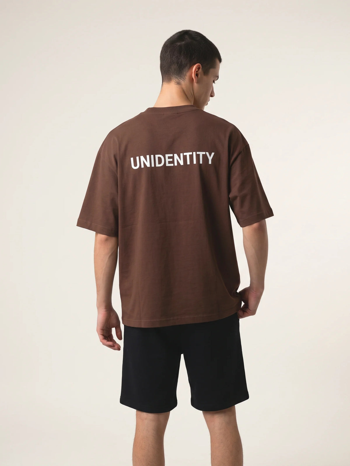 Chocolate heavyweight oversized t-shirt in organic cotton, Unidentity You Tee, back view of the white UNIDENTITY logo, 210gsm, Dubai streetwear #color_chocolate
