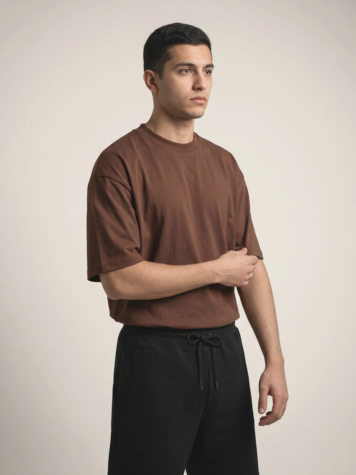 Chocolate organic cotton t-shirt, Unidentity You Oversized Tee, three-quarter front view worn by man showing the clean crew neck, 210gsm #color_chocolate