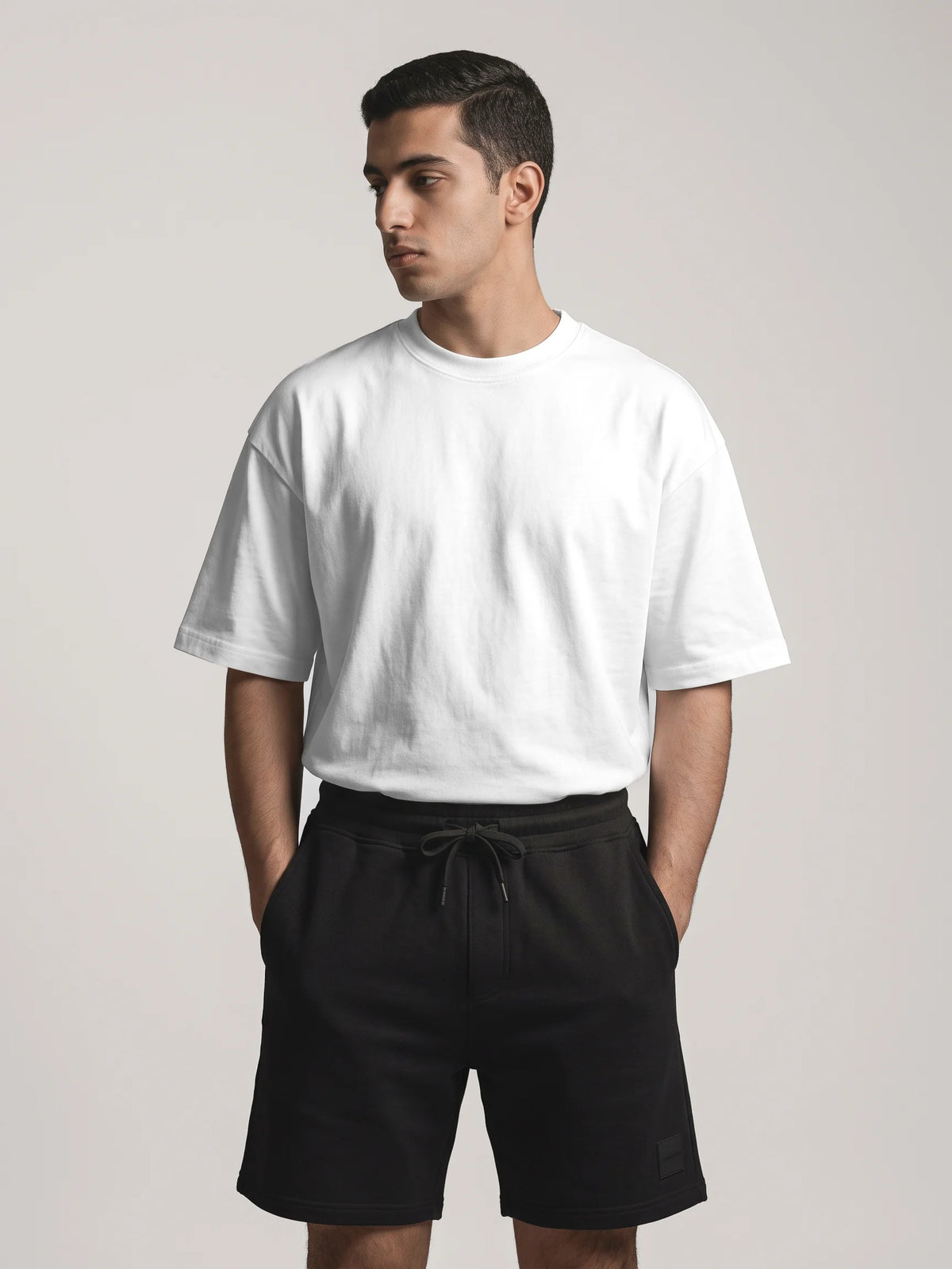 White heavyweight oversized t-shirt, Unidentity You Tee, front view worn by man showing the crew neck with black Core shorts, sustainable streetwear #color_white