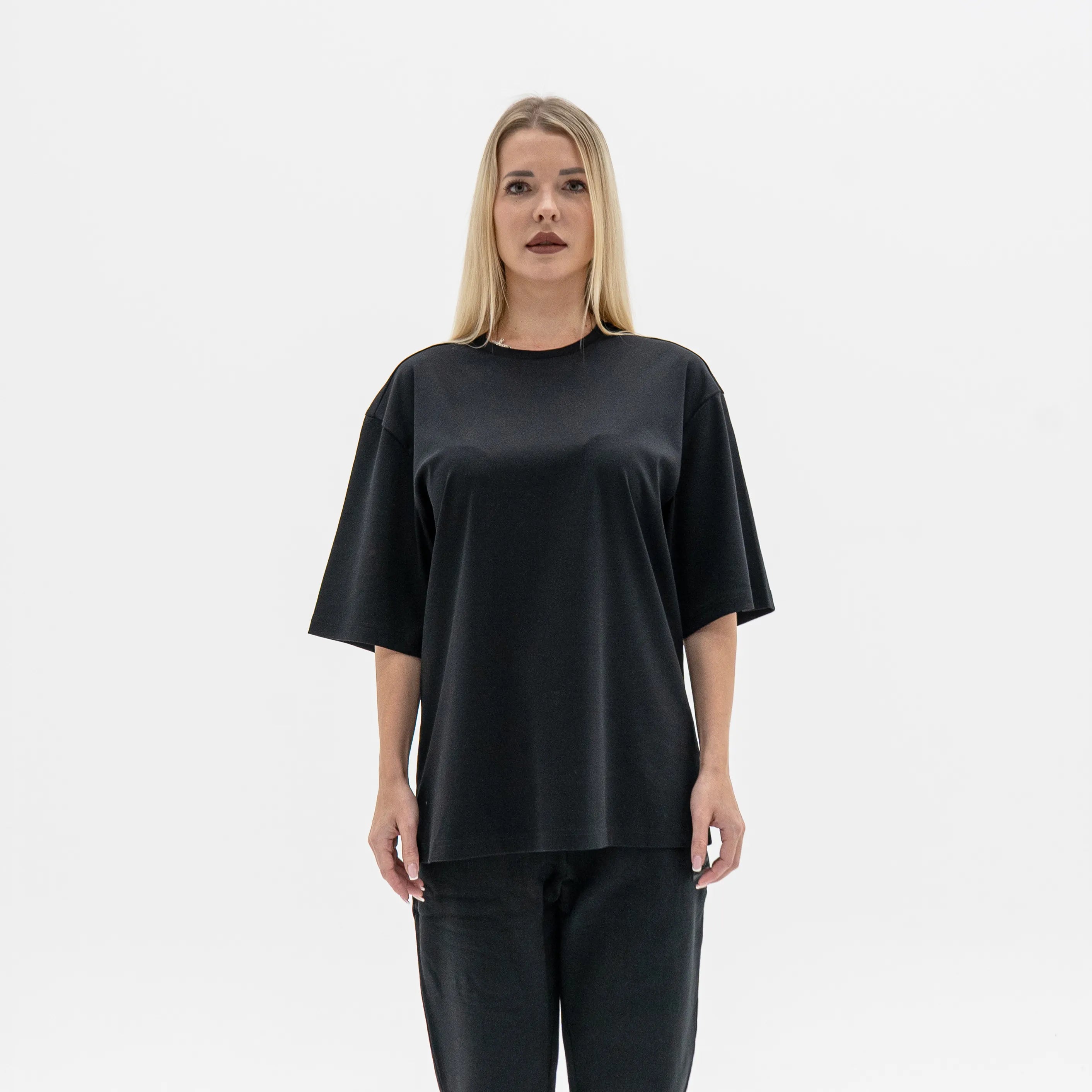 Woman wearing a black outfit on a white background. #color_black