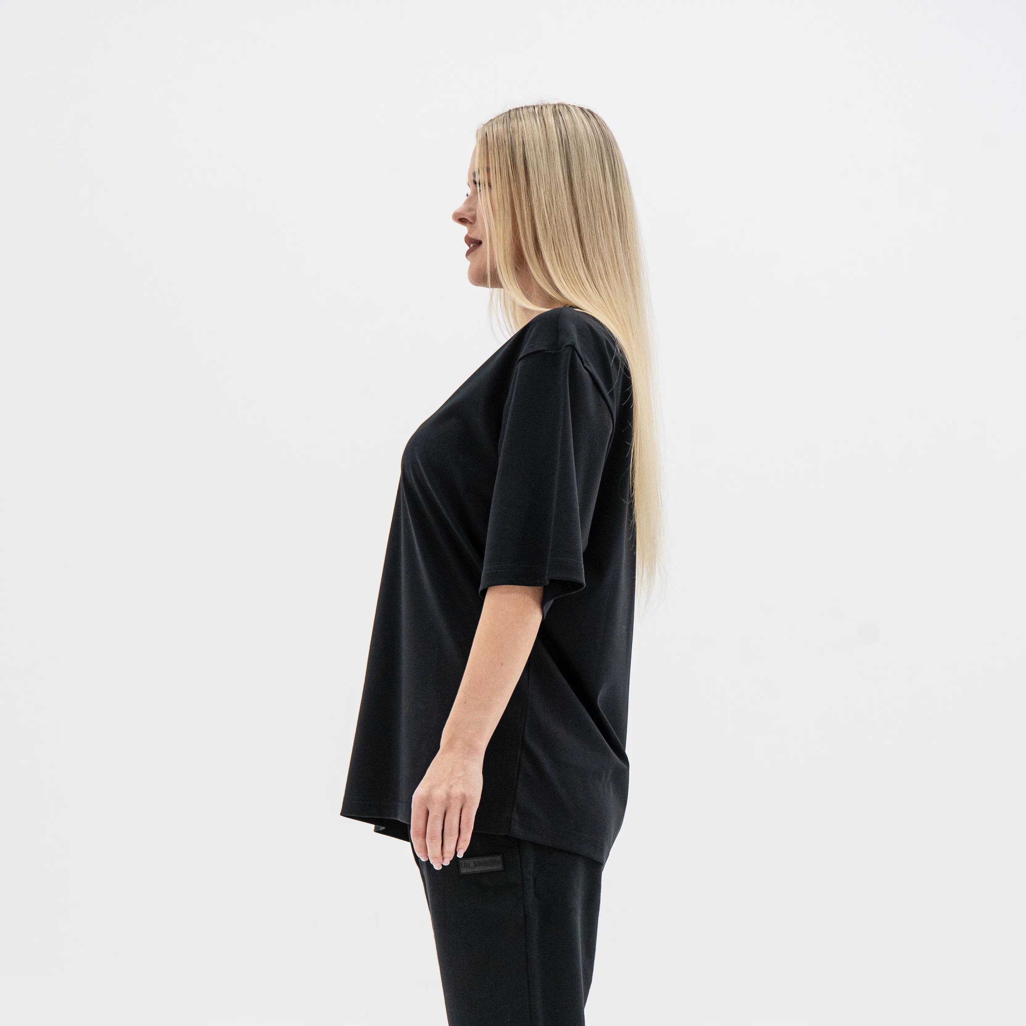 Woman wearing a black outfit on a white background. #color_black