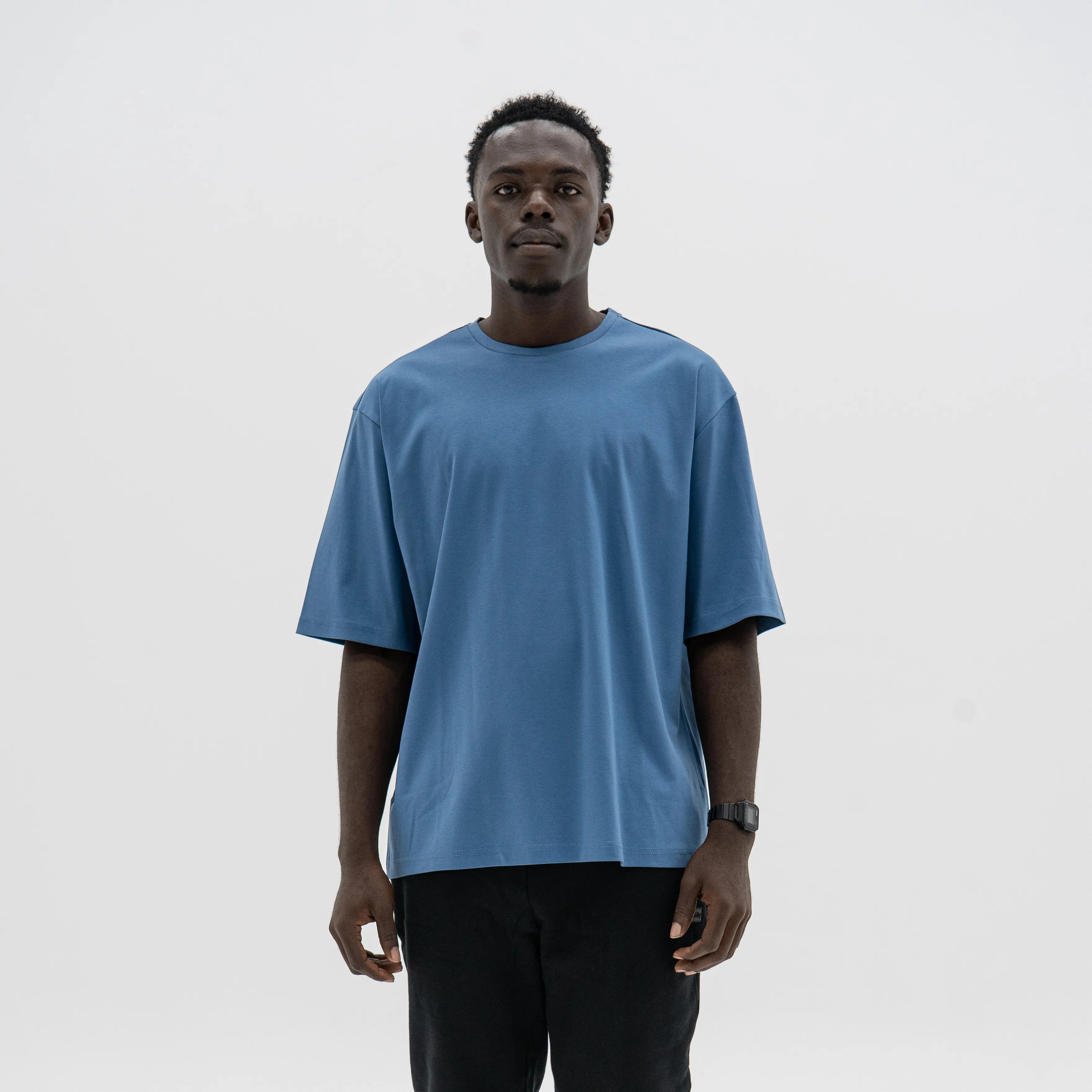 Person wearing a blue t-shirt on a plain background. #color_blue