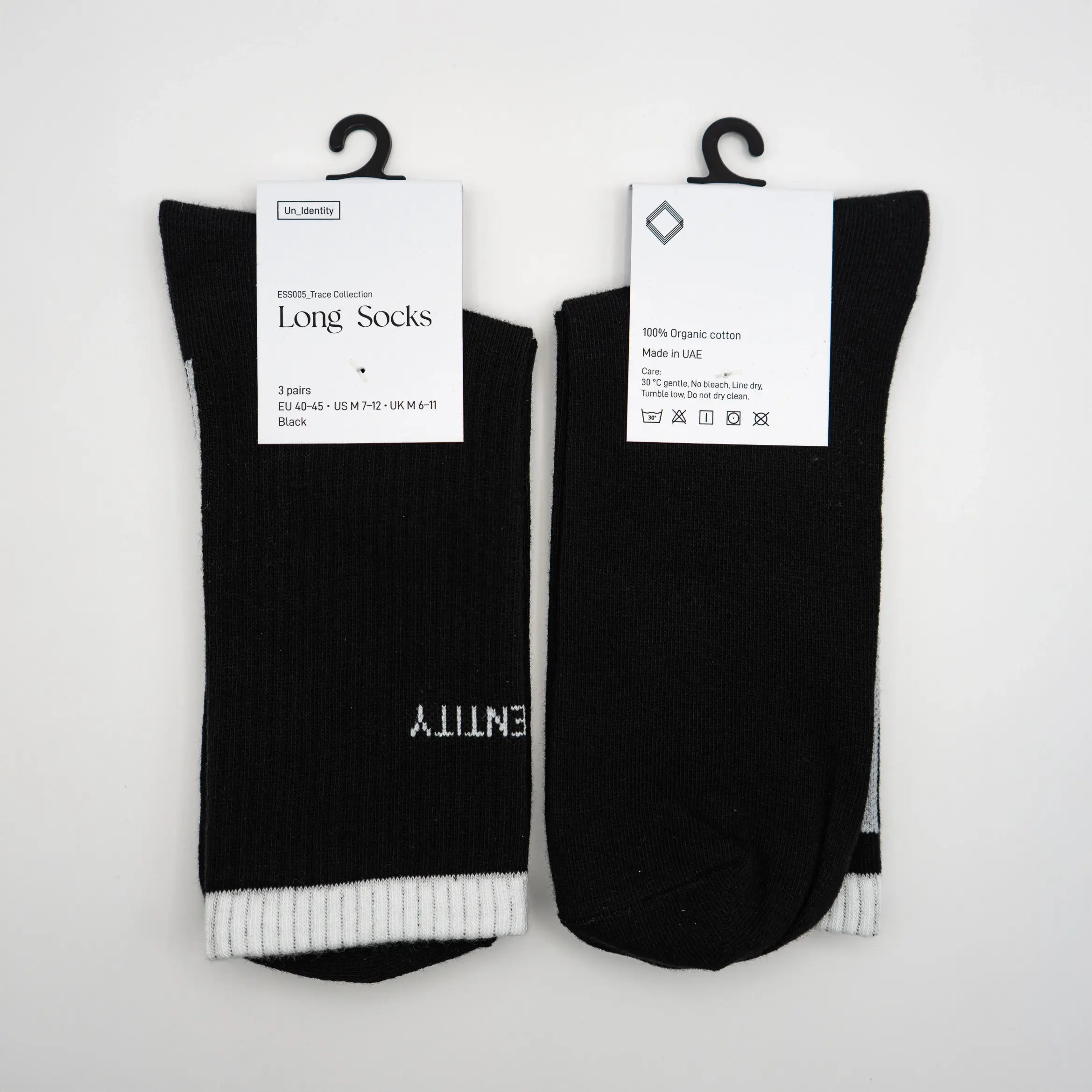 Two pairs of black Unidentity long socks with white cuffs and labels  