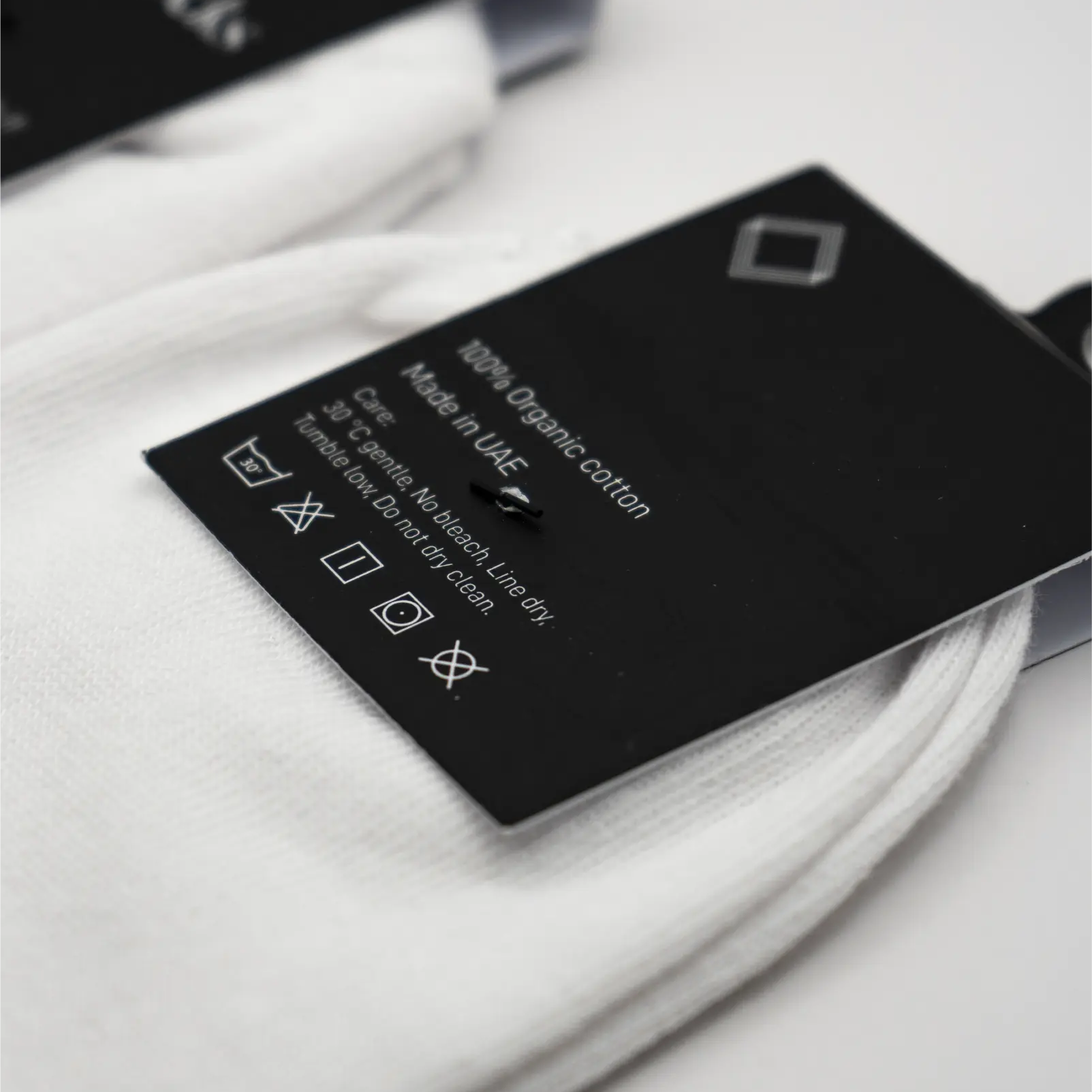Close-up of clothing label on white socks. #color_white