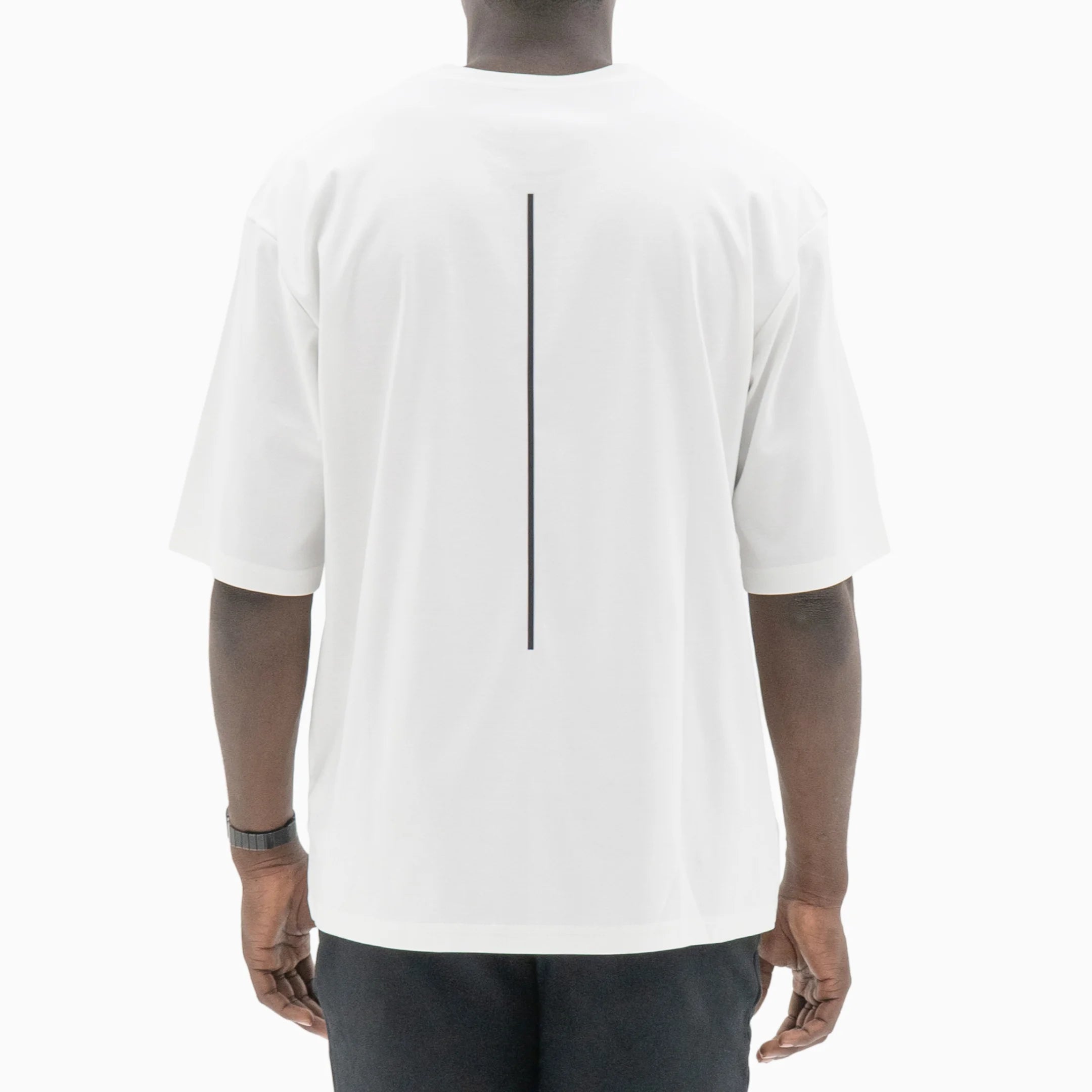 Person wearing a white t-shirt with a black line on the back against a plain background. #color_white