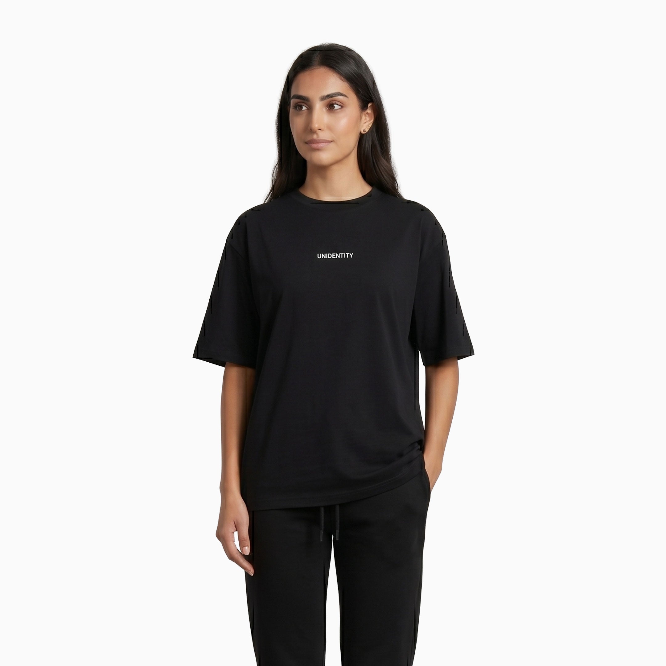 Person wearing a black t-shirt with 'UNIDENTITY' logo on a white background #color_black