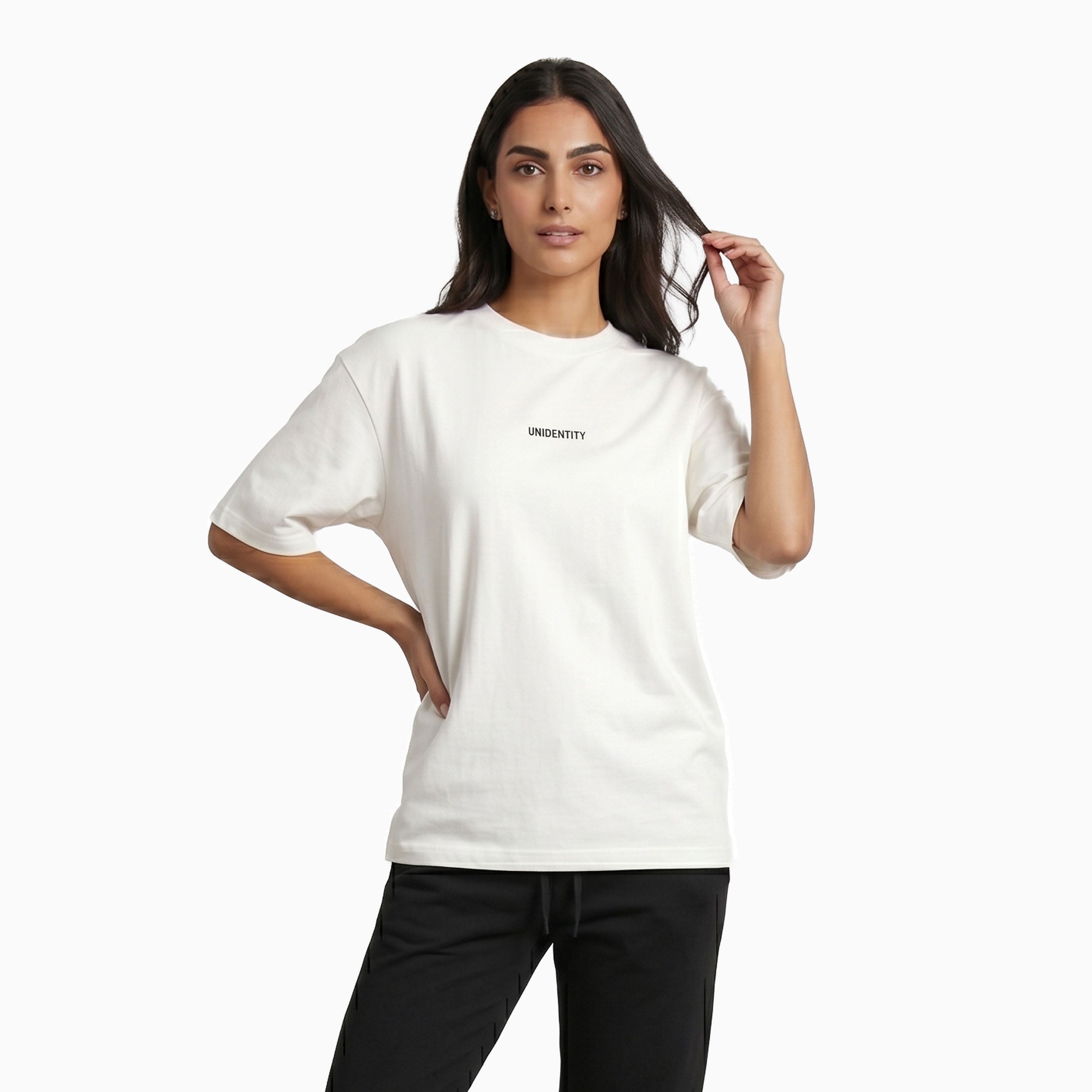 Woman wearing a white t-shirt with text UNIDENTITY on a white background #color_white
