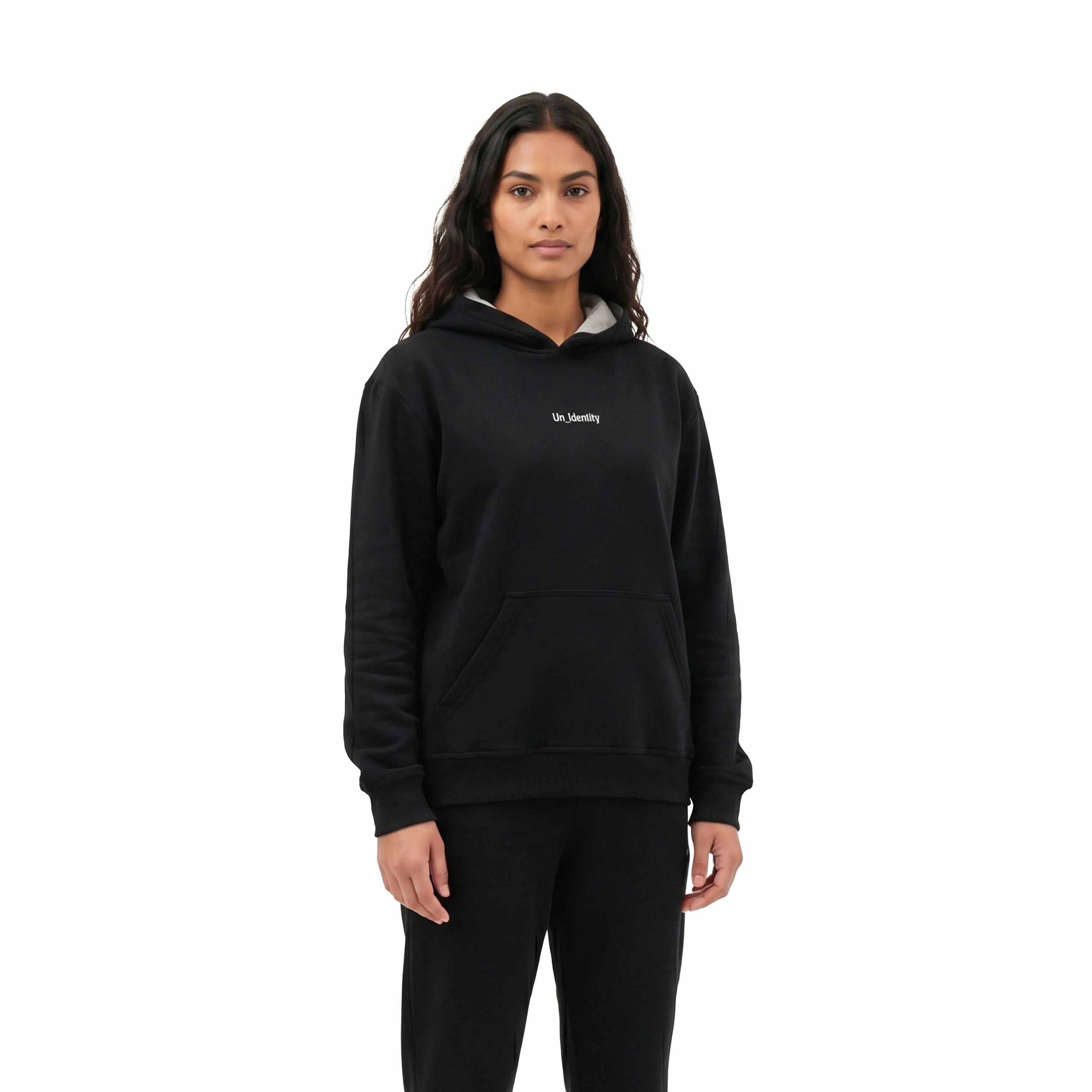 Model wearing black hoodie with Unidentity logo on the chest and black pants. #color_black