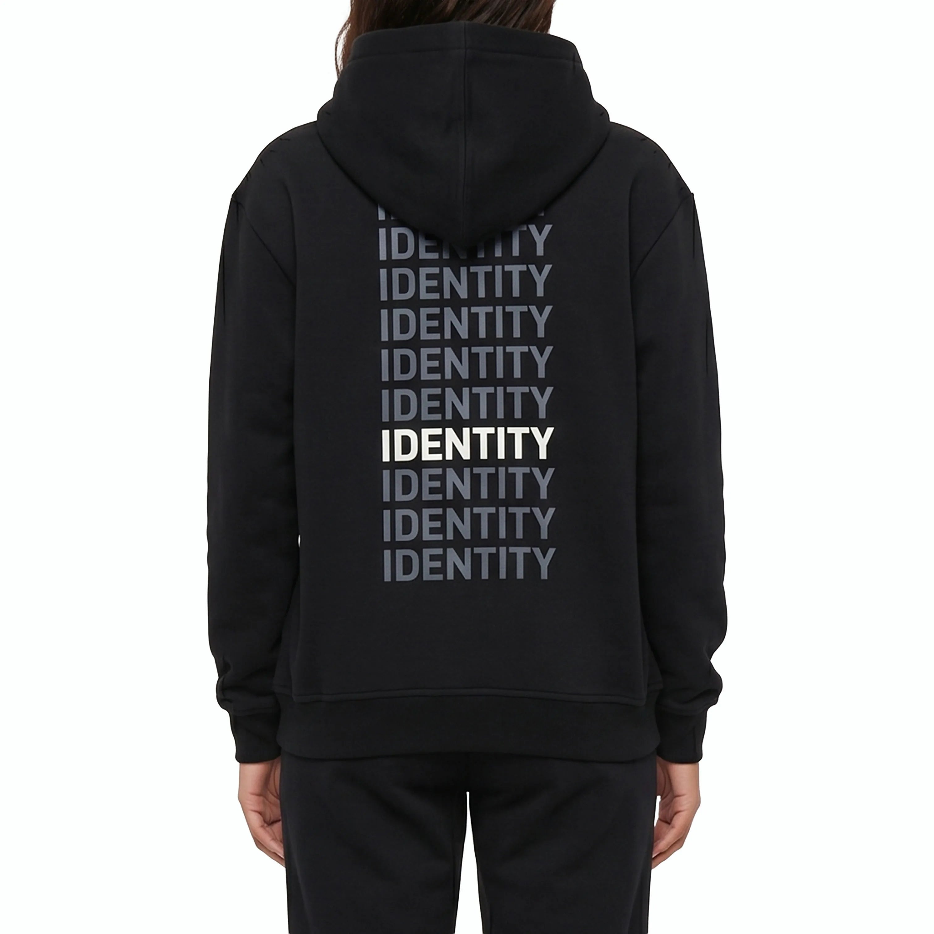 Beige black with identity text on the back  on model. #color_black
