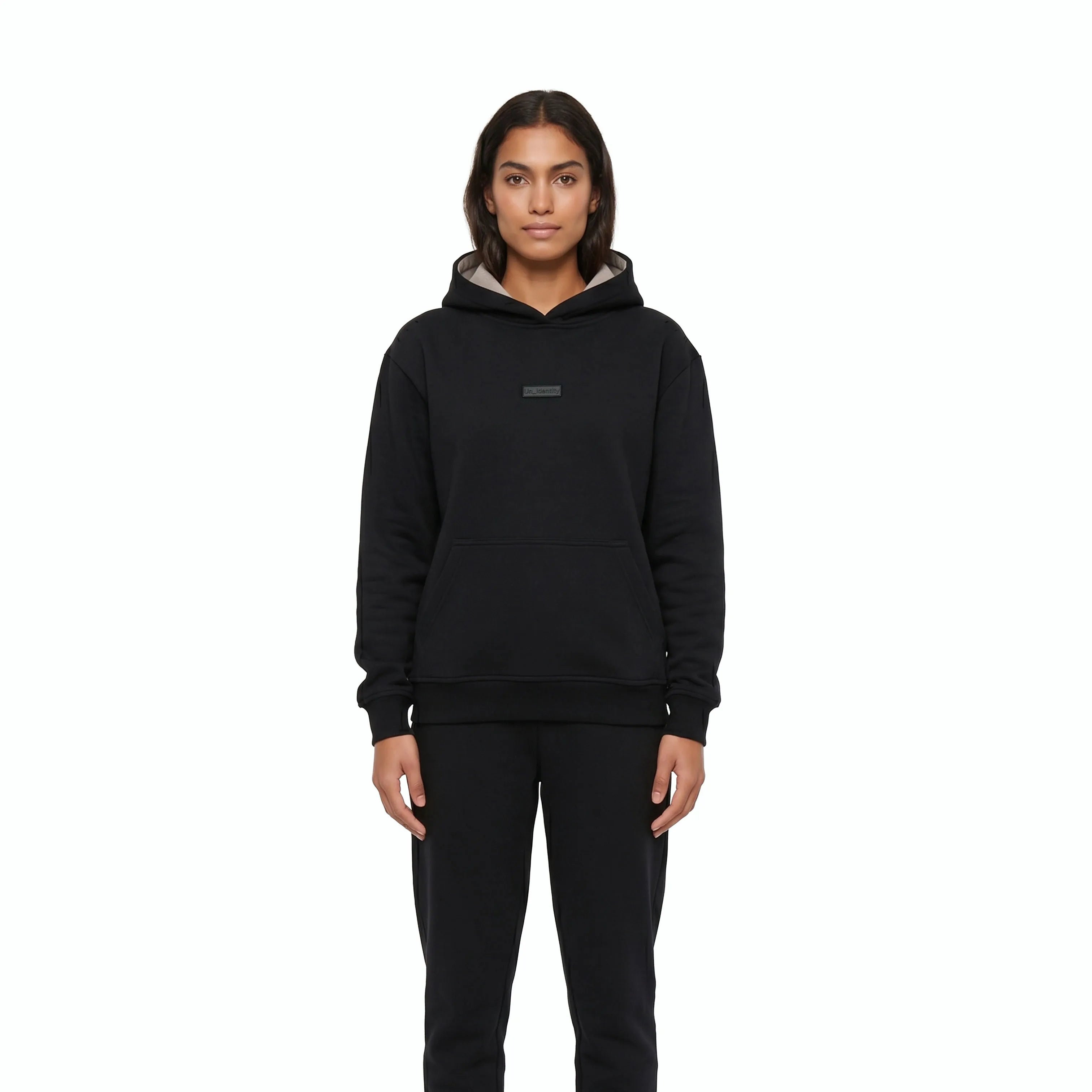 Woman wearing black Unidentity hoodie and black pants. #color_black
