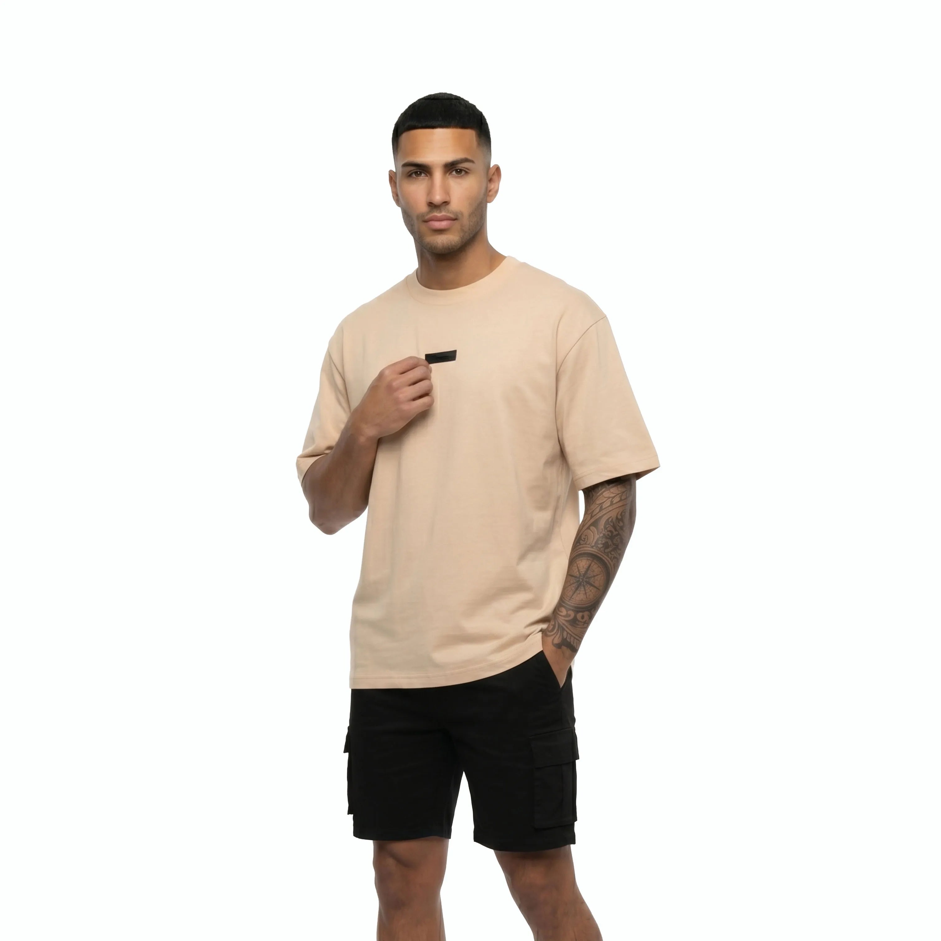 Man wearing Unidentity beige tee and black shorts. #color_beige
