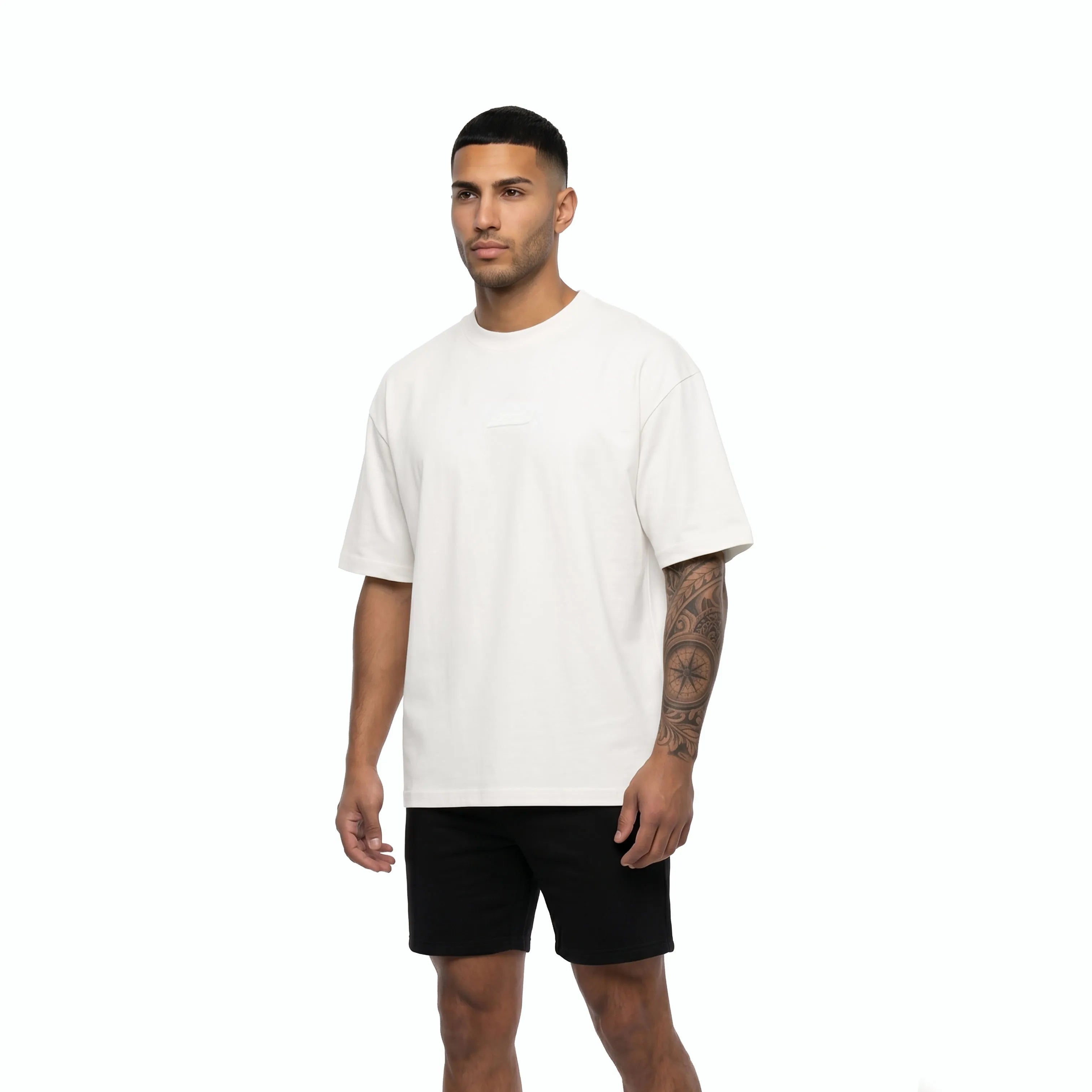 Man wearing Unidentity white tee and black shorts. #color_white