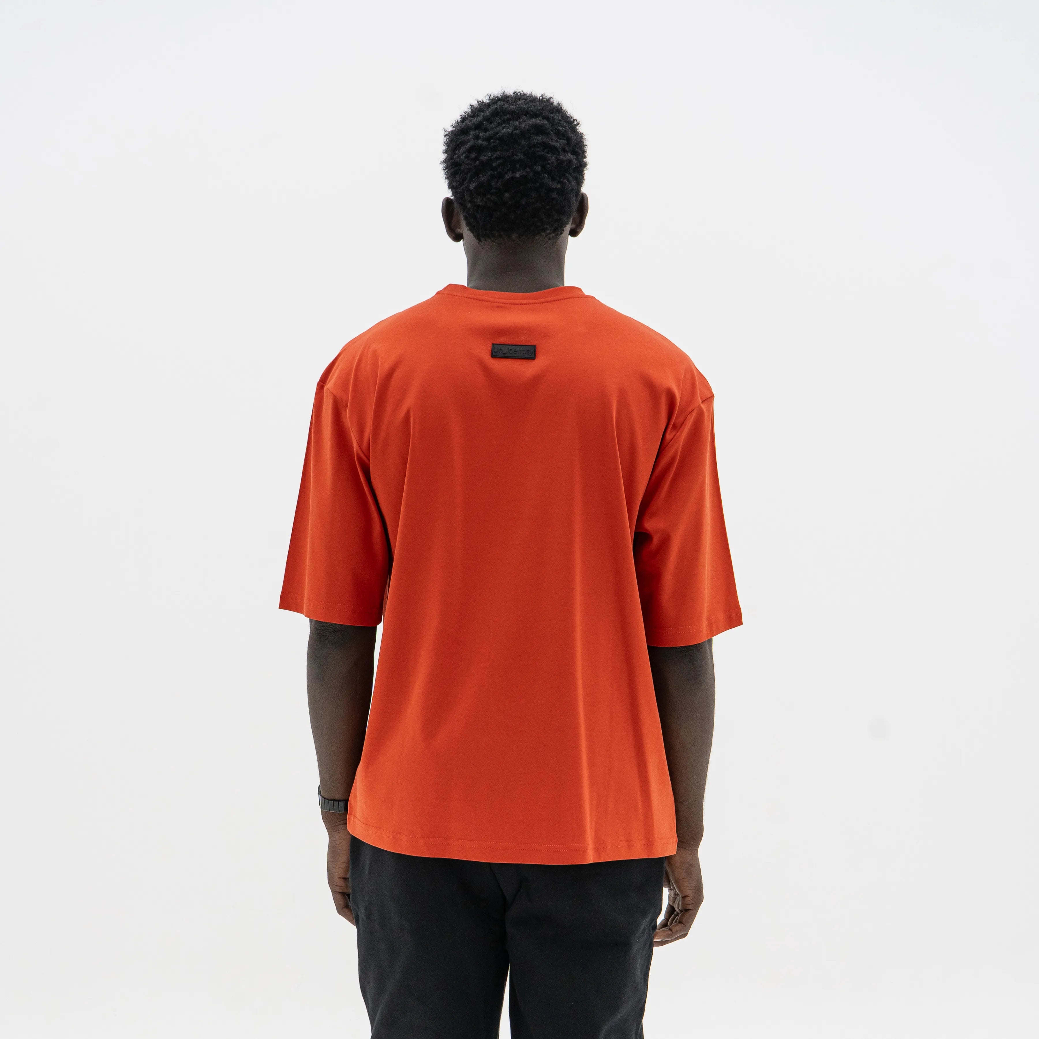 Person wearing an red t-shirt on a white background. #color_red