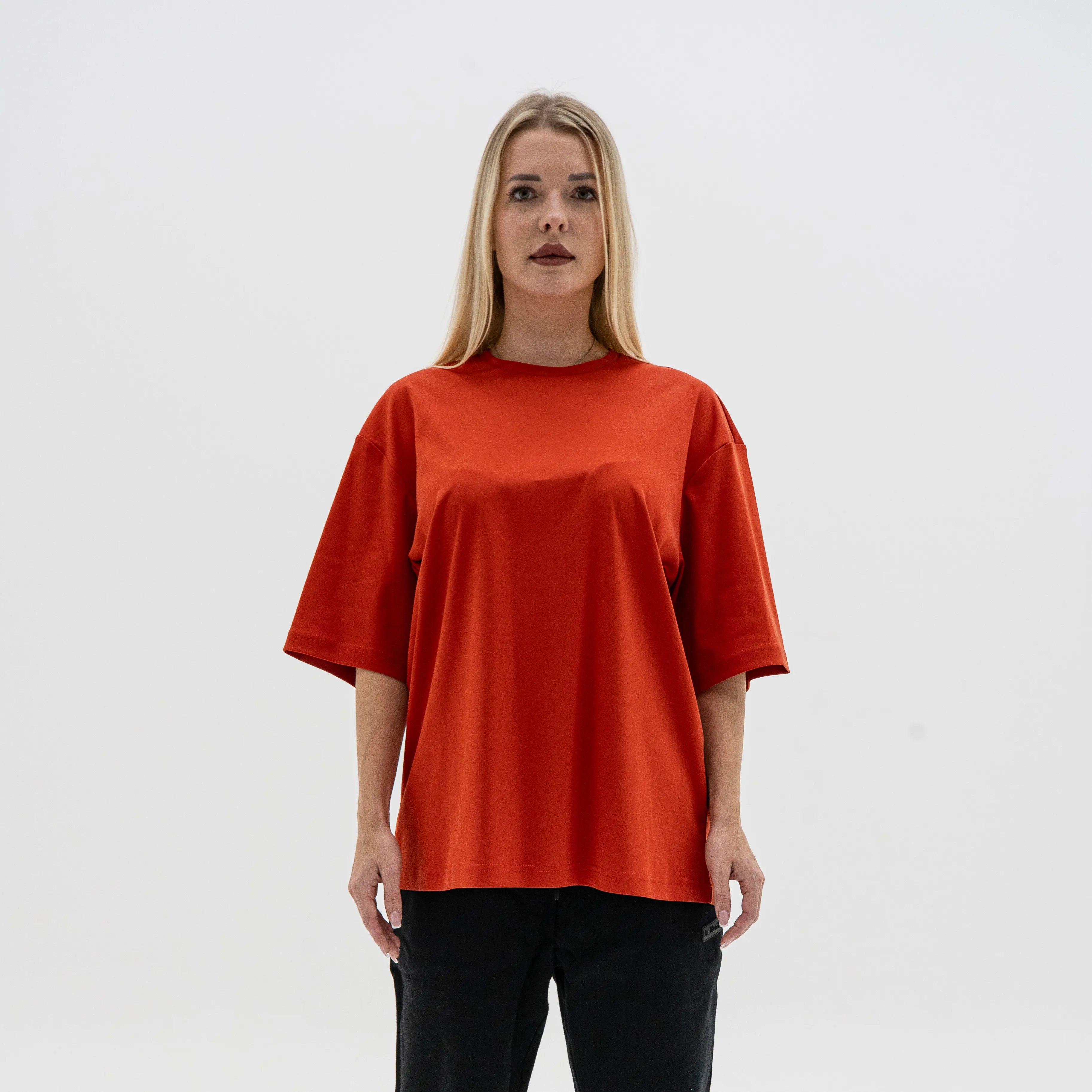 Person wearing a red oversized t-shirt on a white background. #color_red