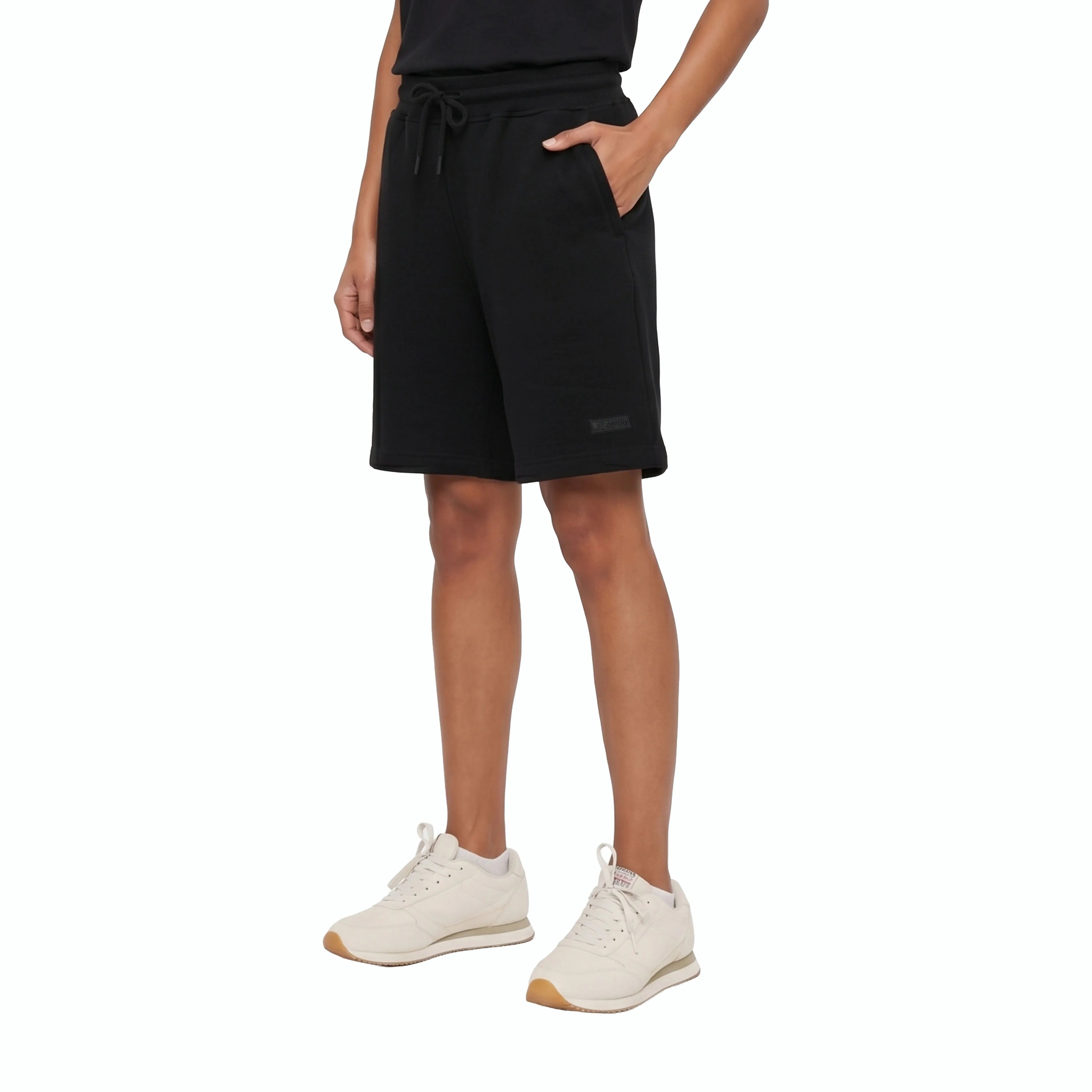 Person wearing black shorts with drawstring and tonal Unidentity logo