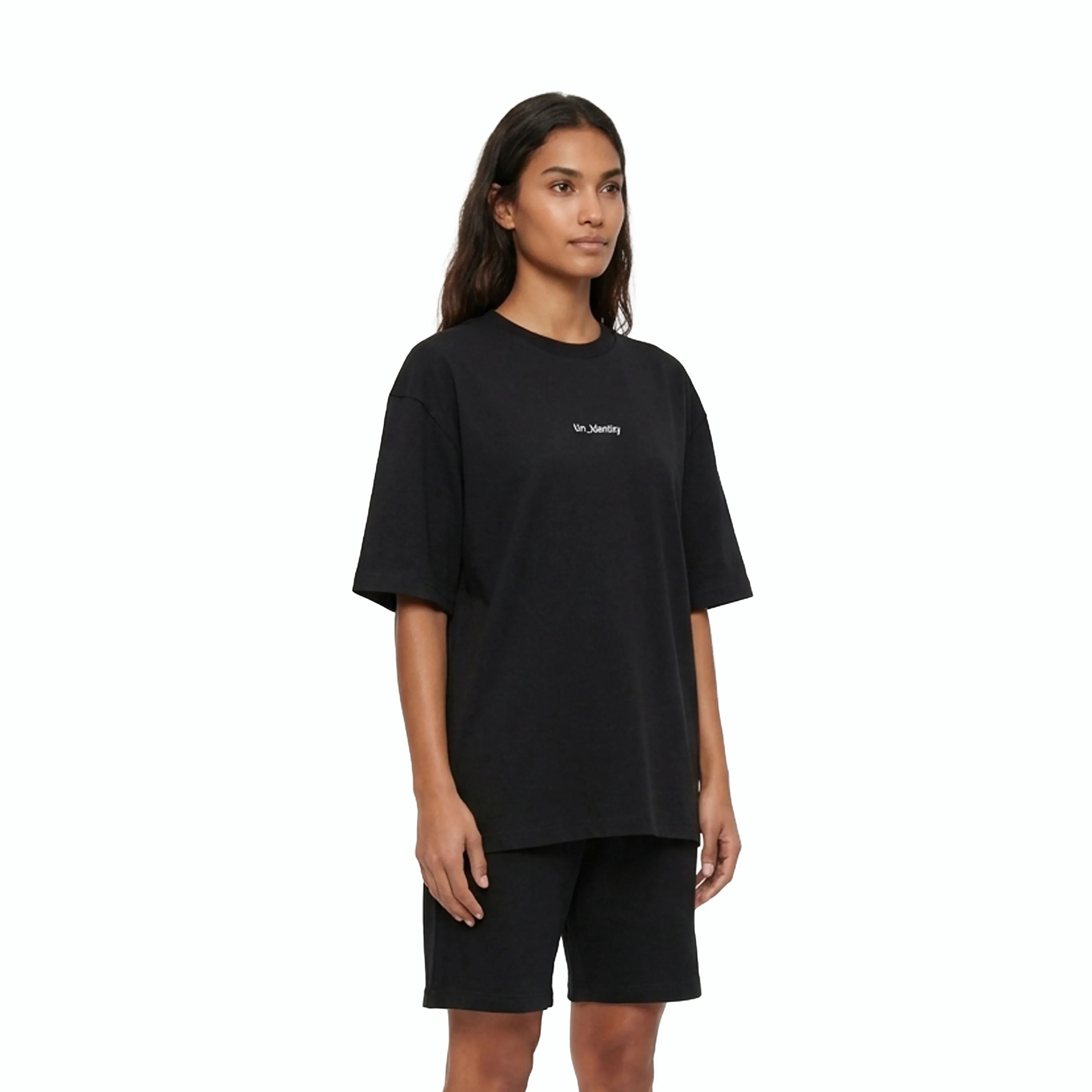 Model wearing black tee with Unidentity logo on the chest and black shorts. #color_black