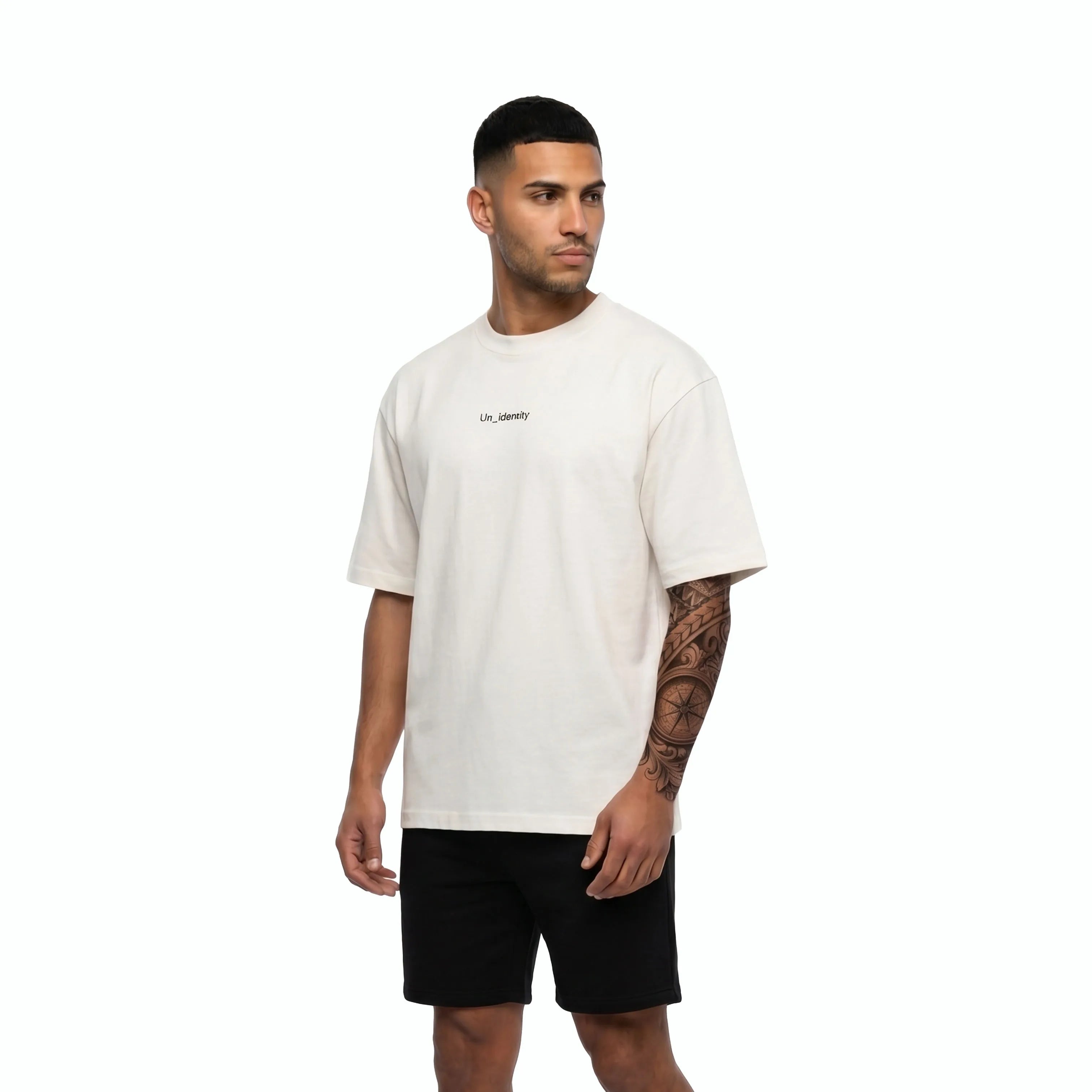 Model wearing white tee with Unidentity logo on the chest and black shorts. #color_white