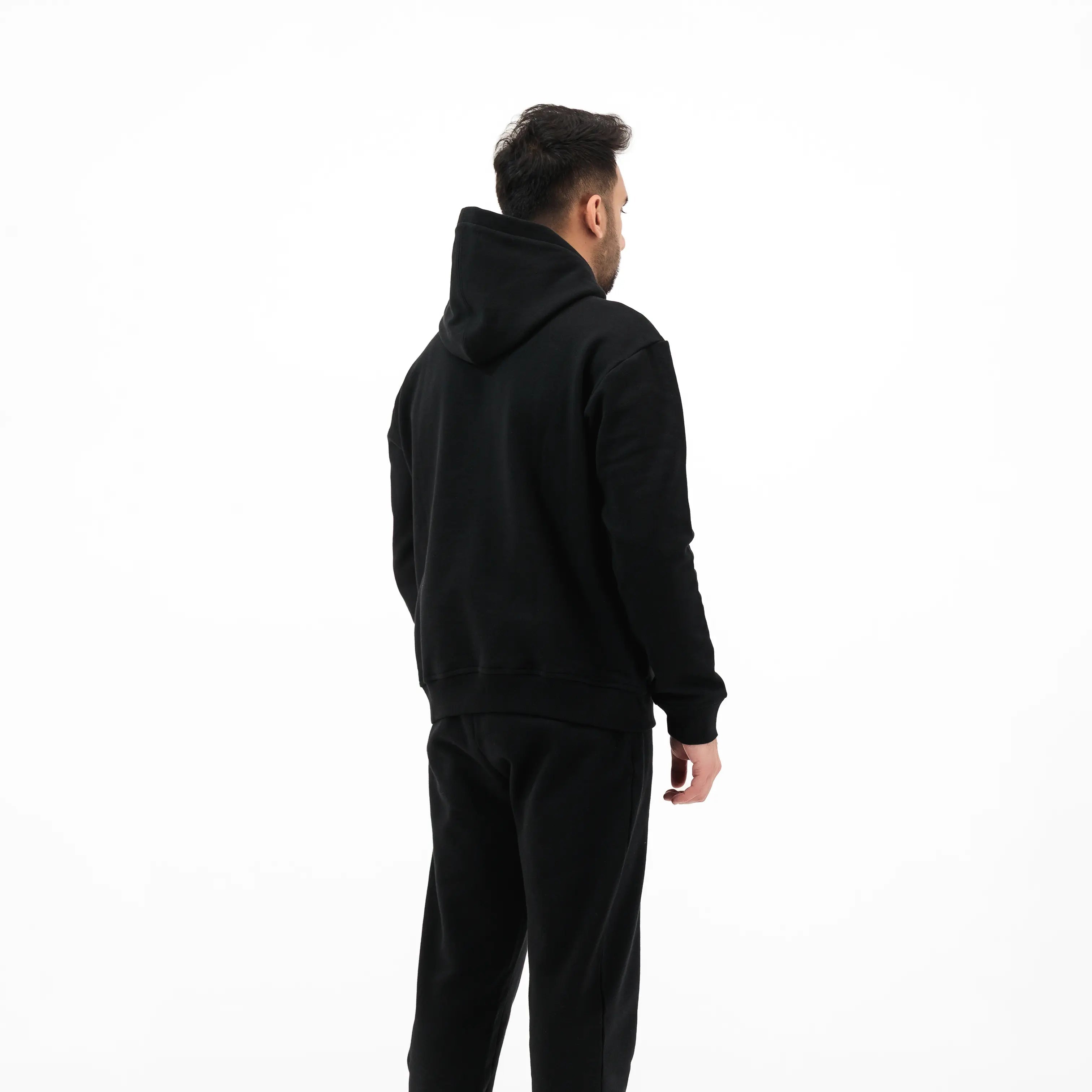 Black hoodie and pants on model. #color_black