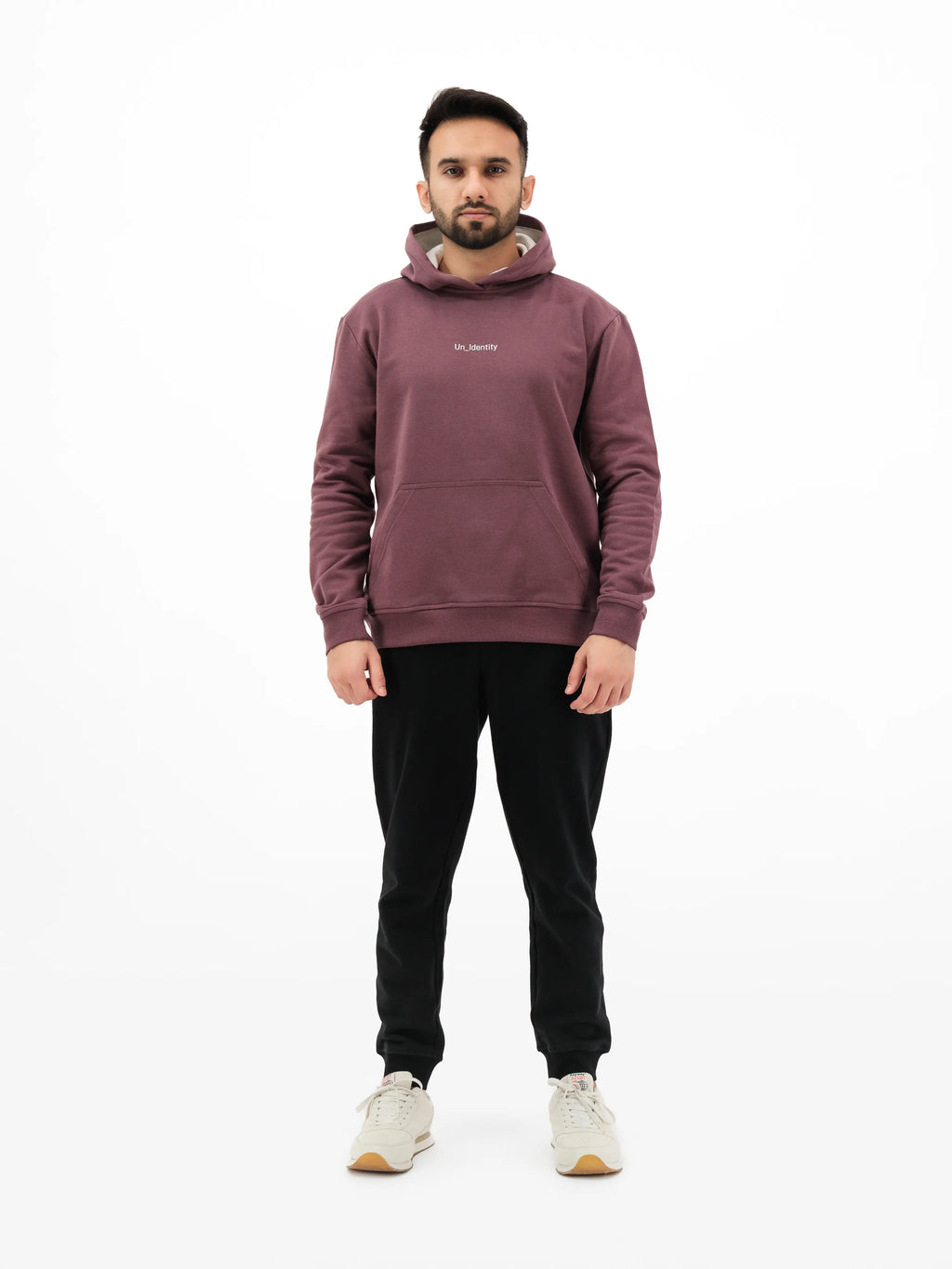 Man wearing maroon hoodie and black pants 