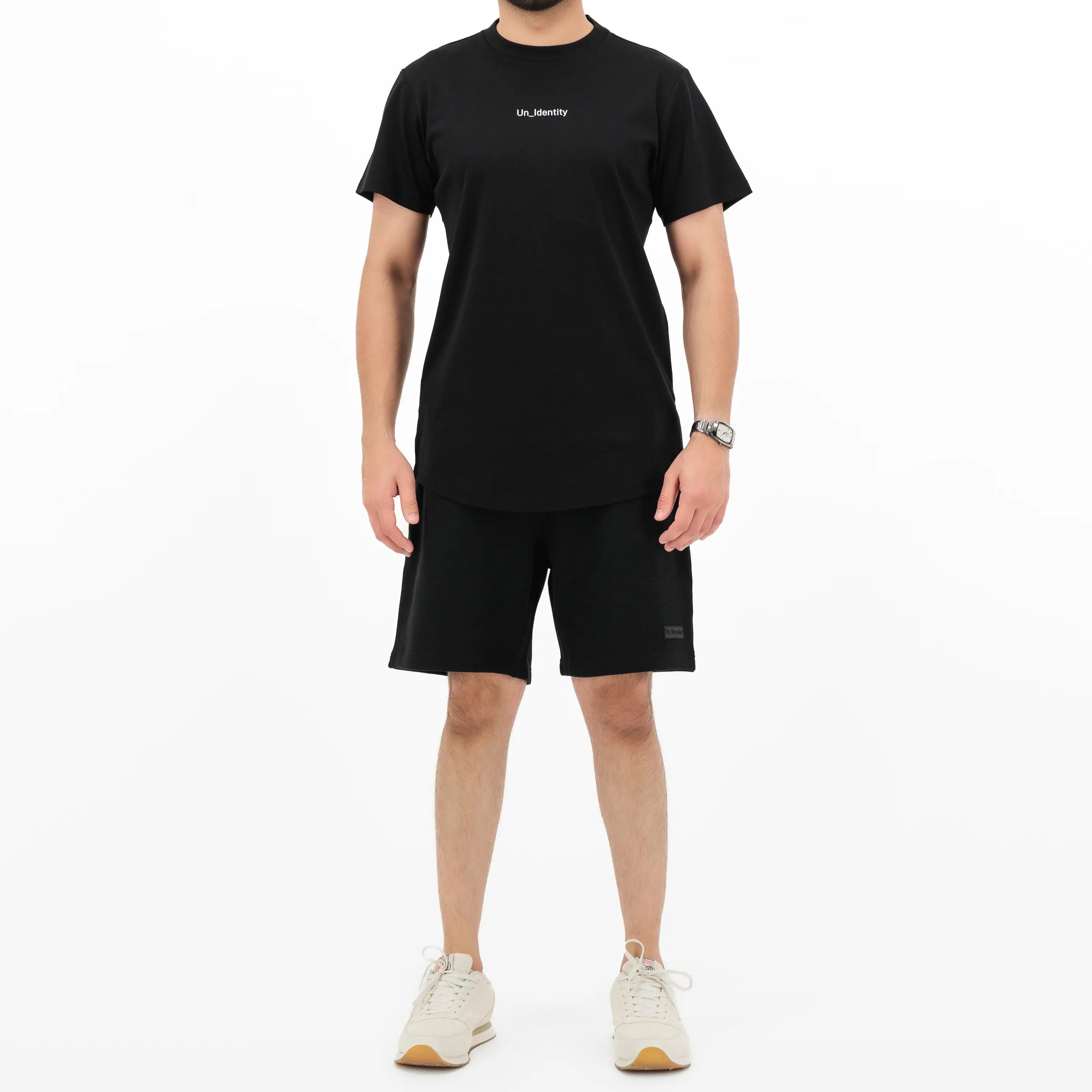 Man wearing Unidentity black tee and shorts. #color_black