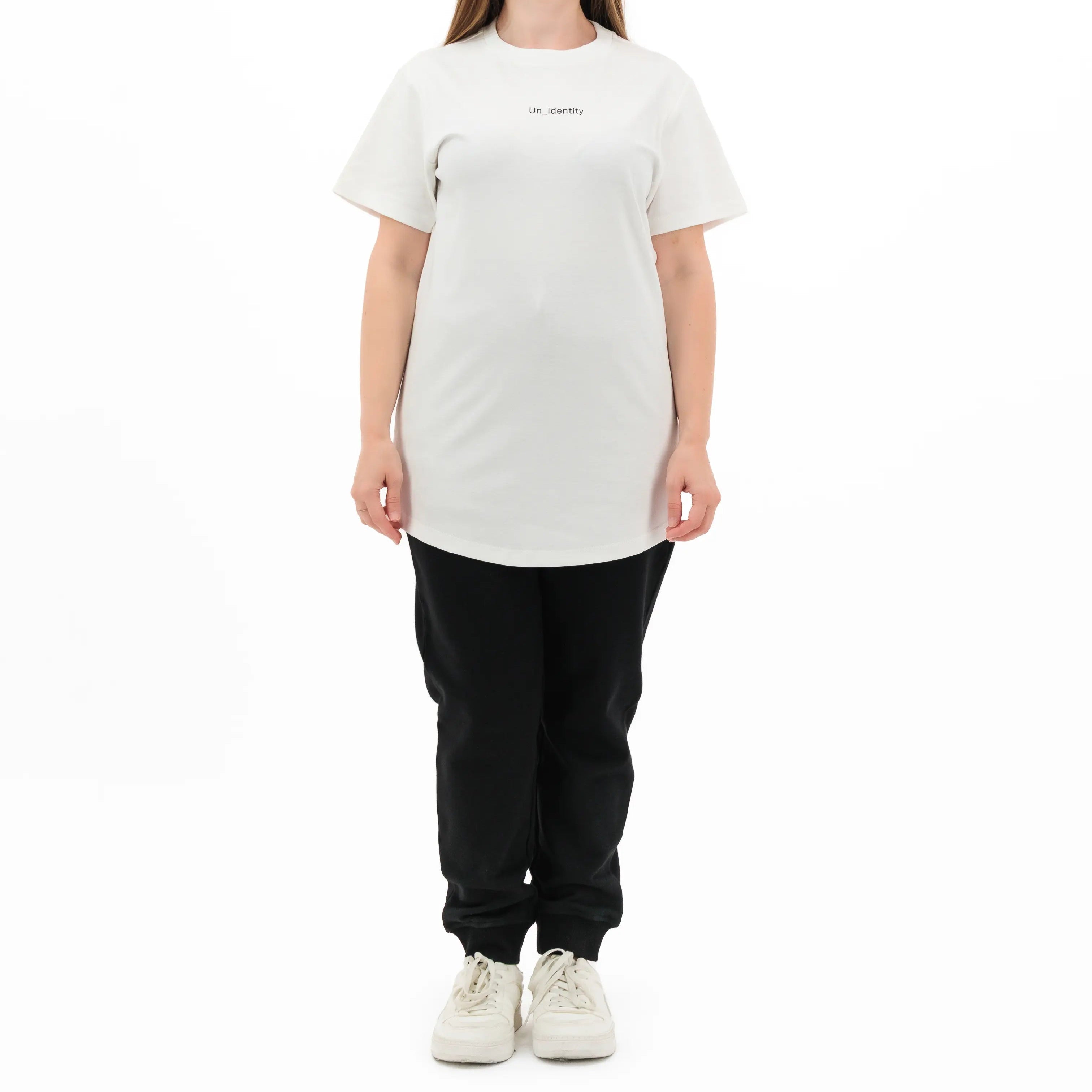 Woman wearing Unidentity white tee and joggers. #color_white