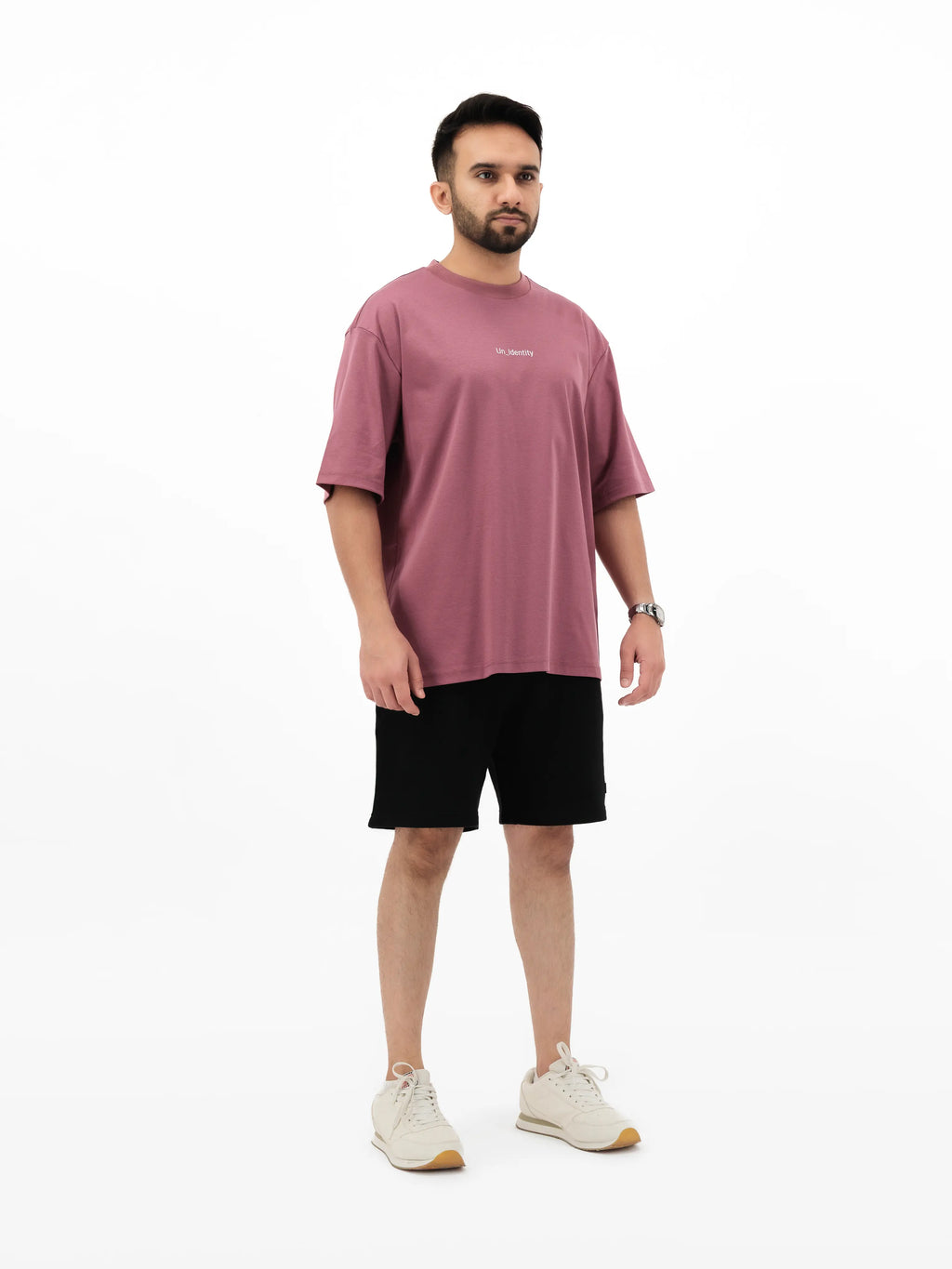 Model wearing Unidentity plum T-shirt and black shorts