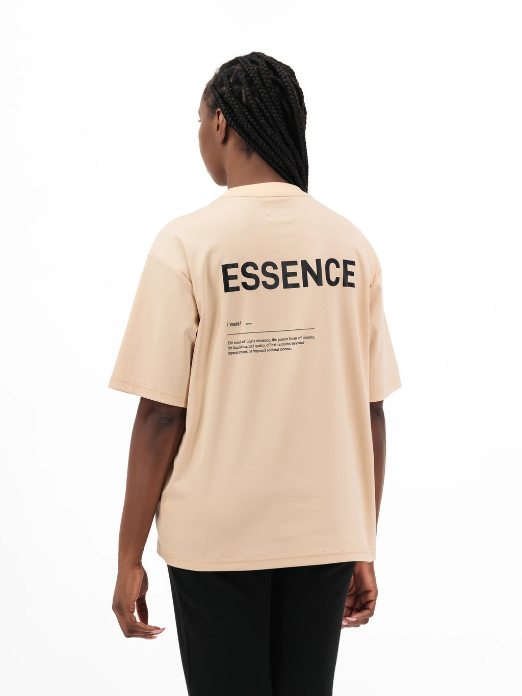 Person wearing beige Unidentity T-shirt with ESSENCE printed on the back