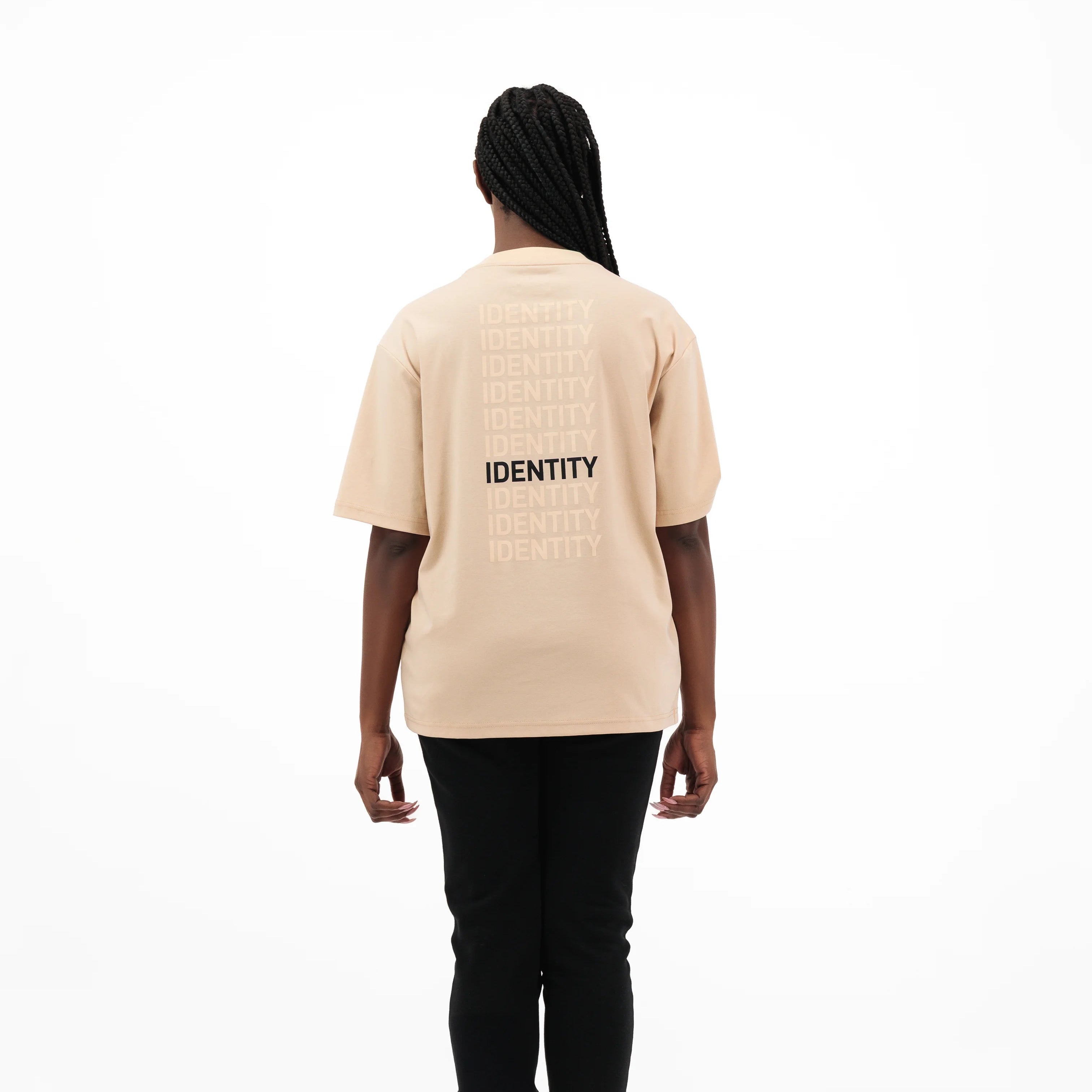Model wearing beige t-shirt with identity text on the back 