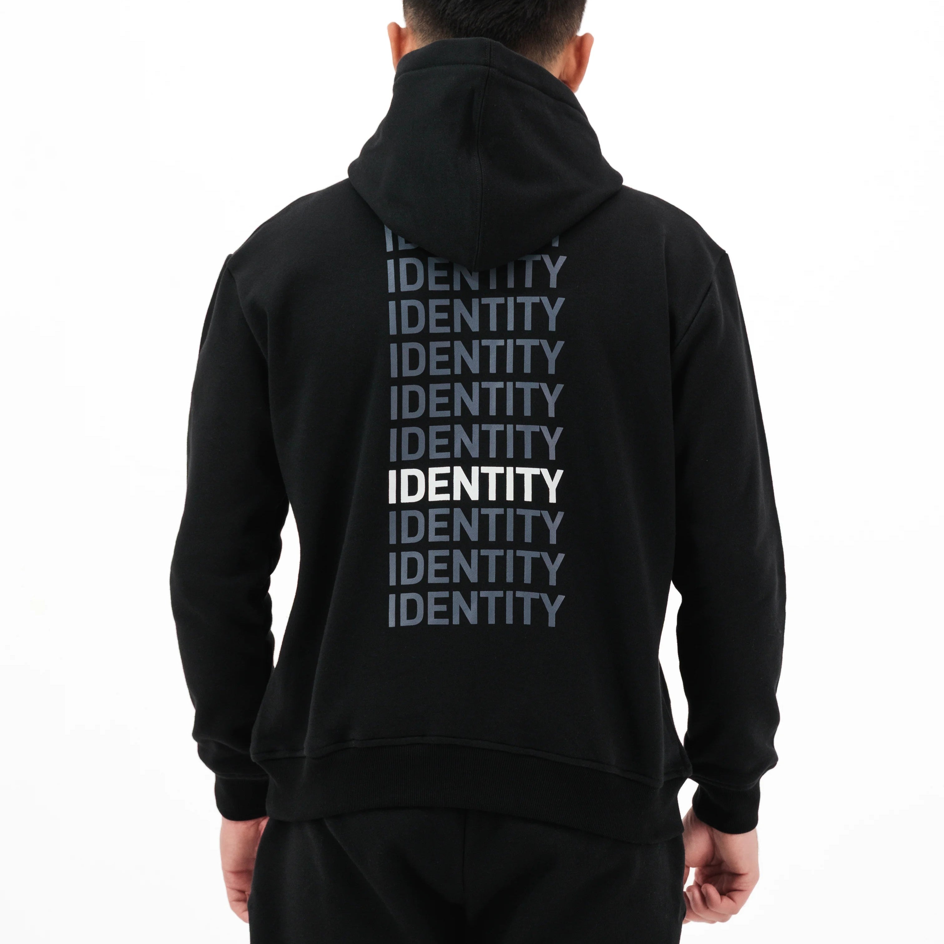 Person wearing black hoodie with identity printed on the back