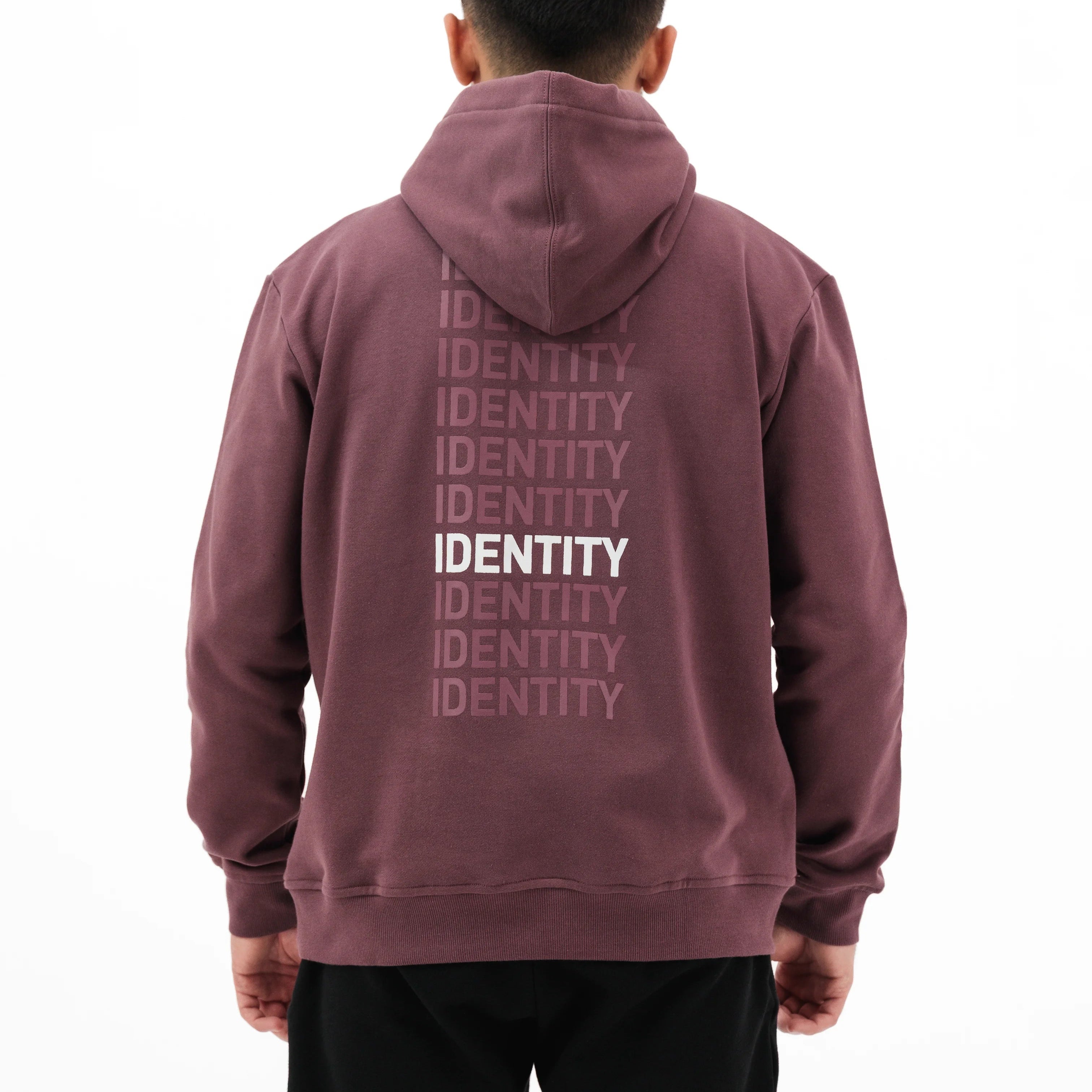 Person wearing plum hoodie with identity text on the back
