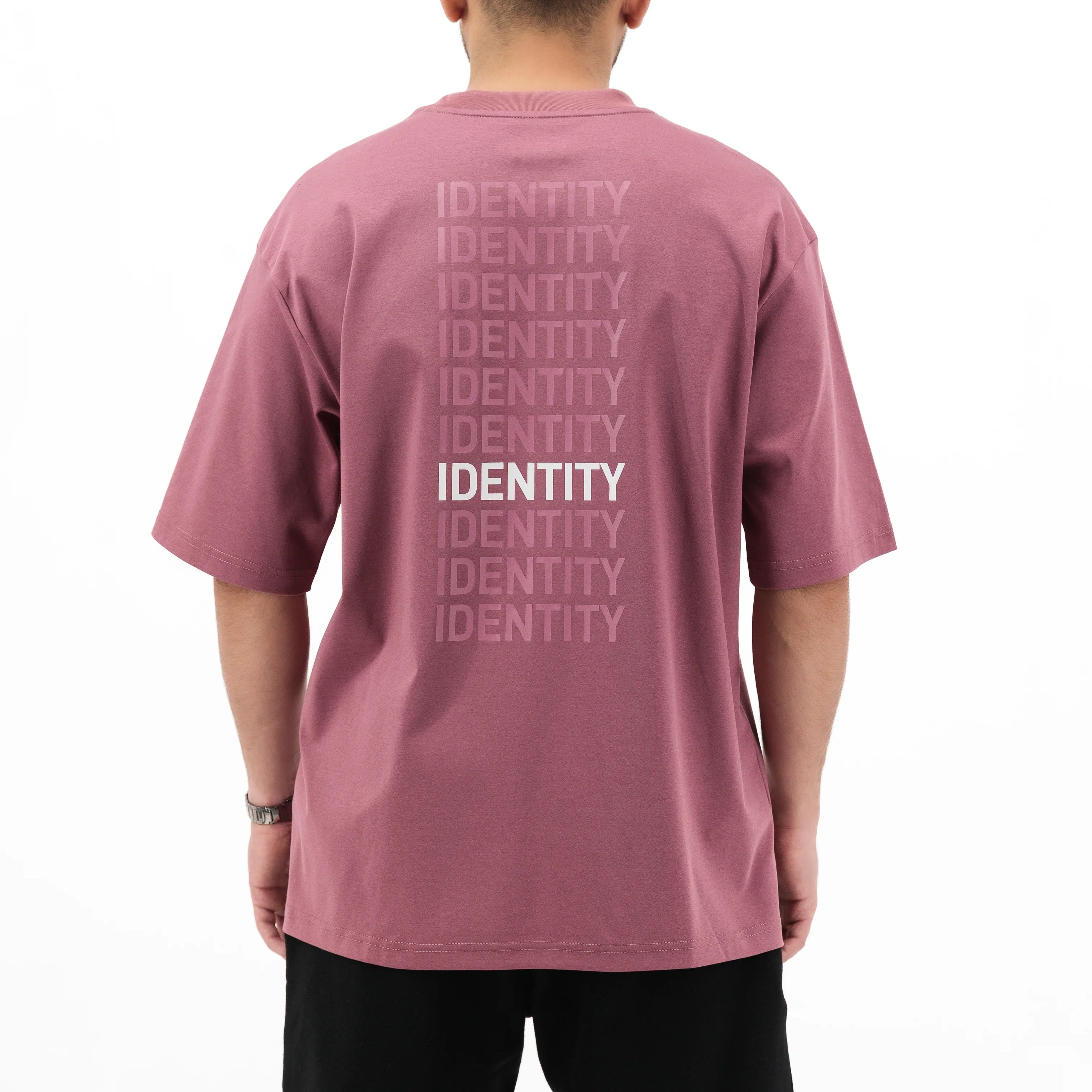 Person wearing plum Unidentity T-shirt with identity printed on the back. #color_plum