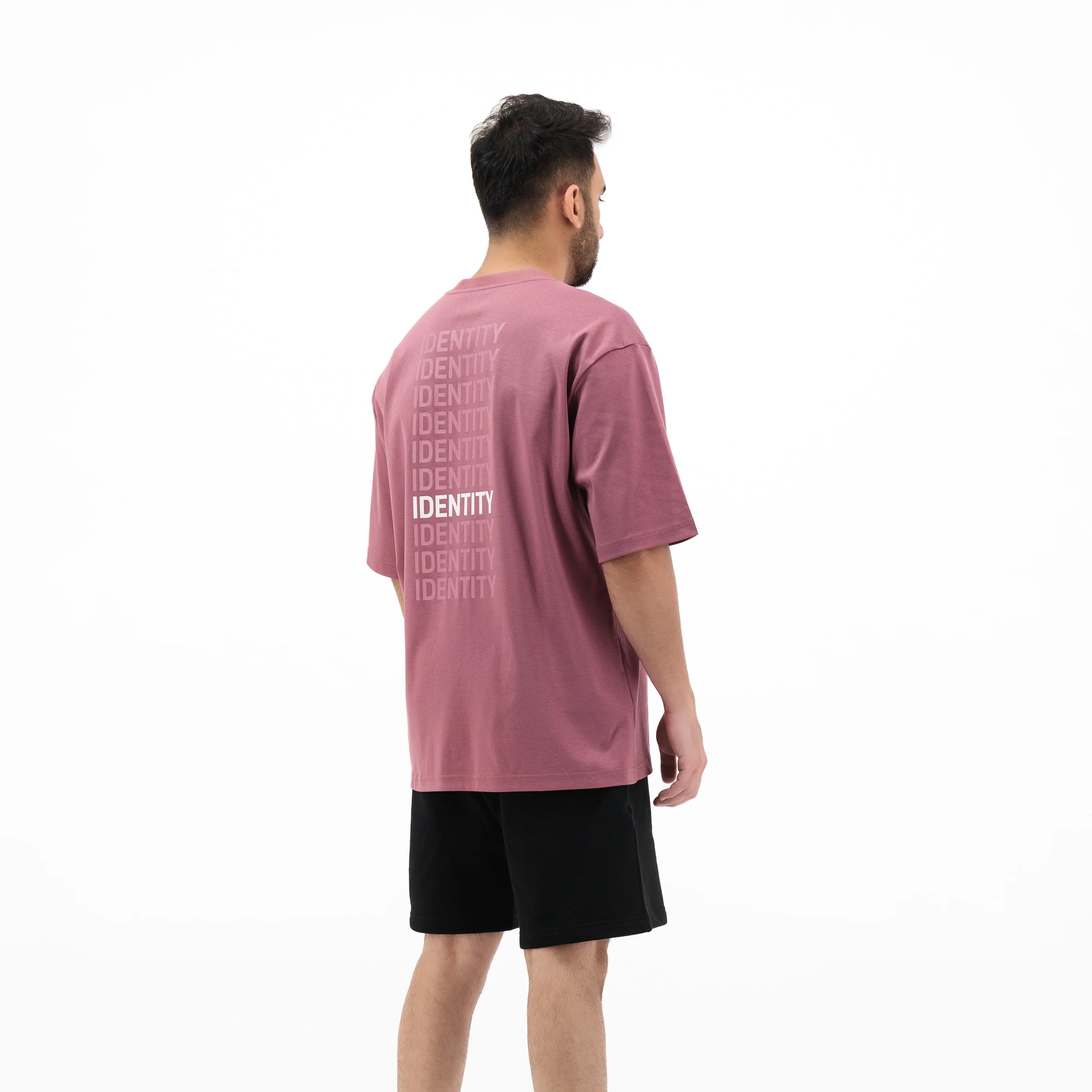 Model wearing pink T-shirt with identity text on the back