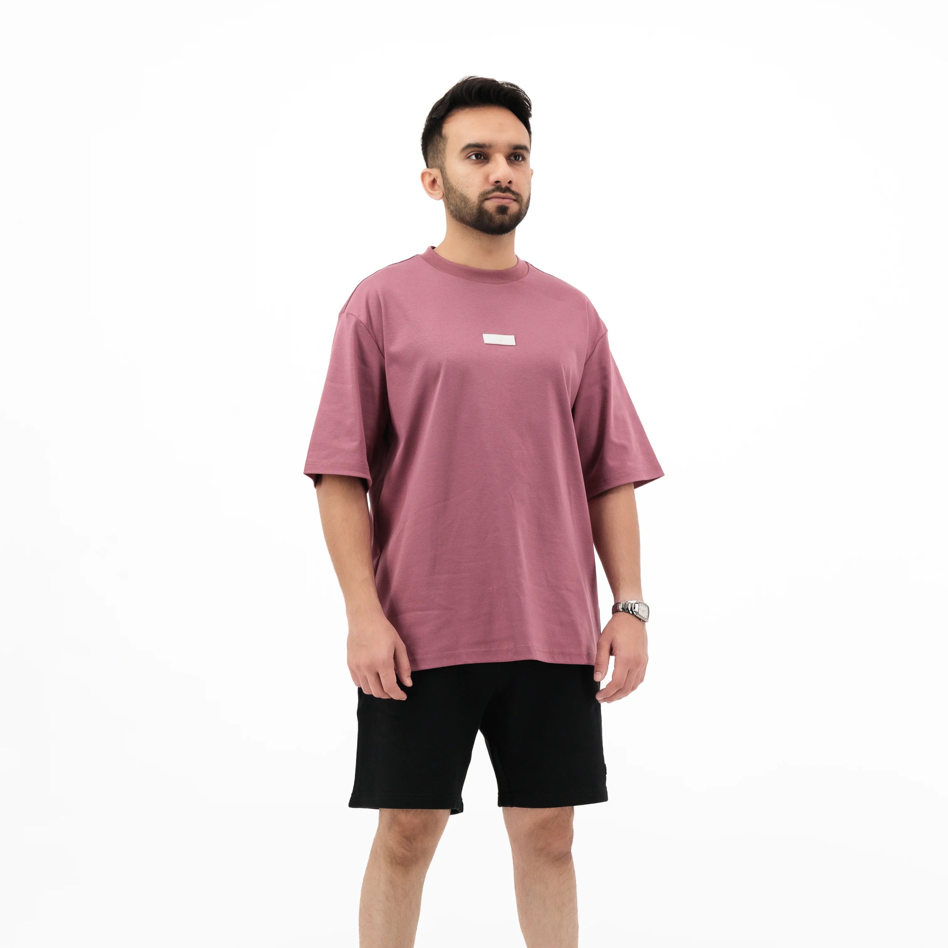 Man wearing Unidentity plum tee and black shorts