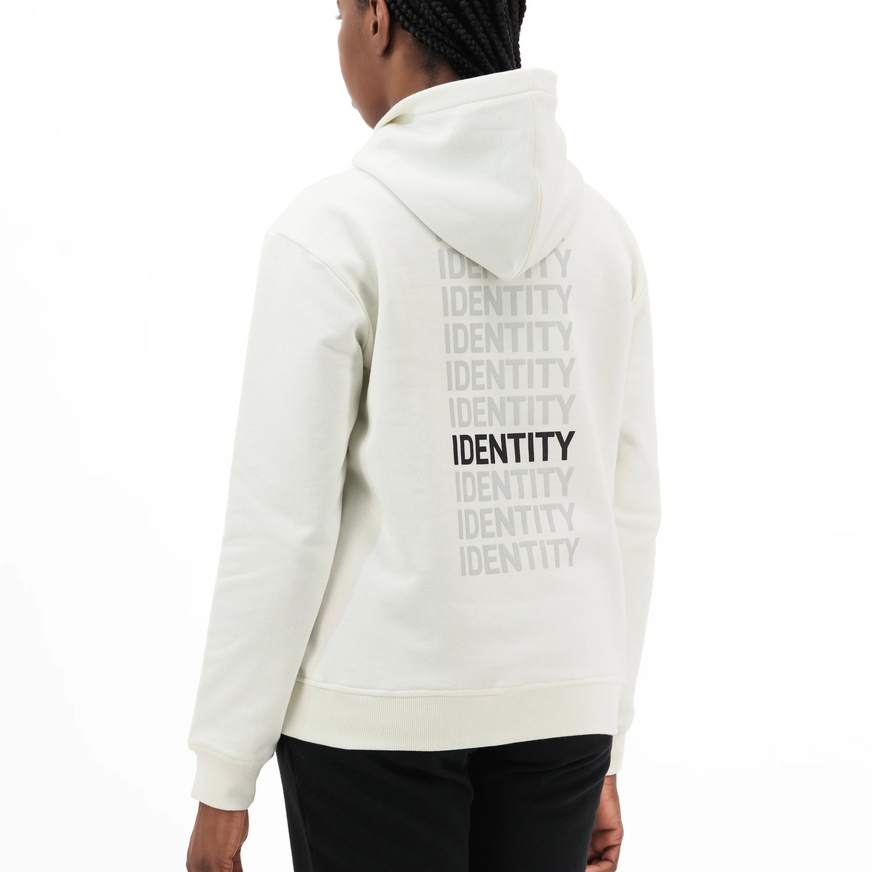 Model wearing white hoodie with identity printed on the back